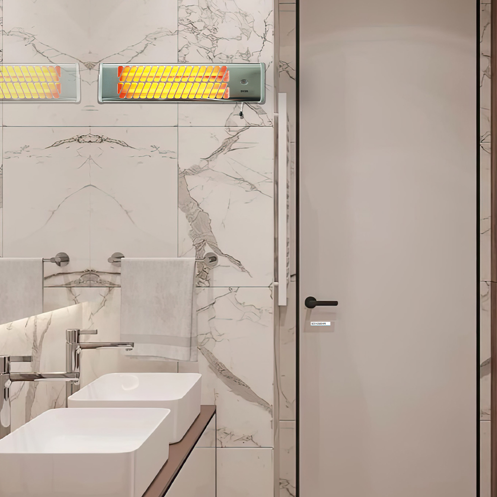 Un baño con dos calentadores de pared con barras naranjas brillantes y dos lavabos.
