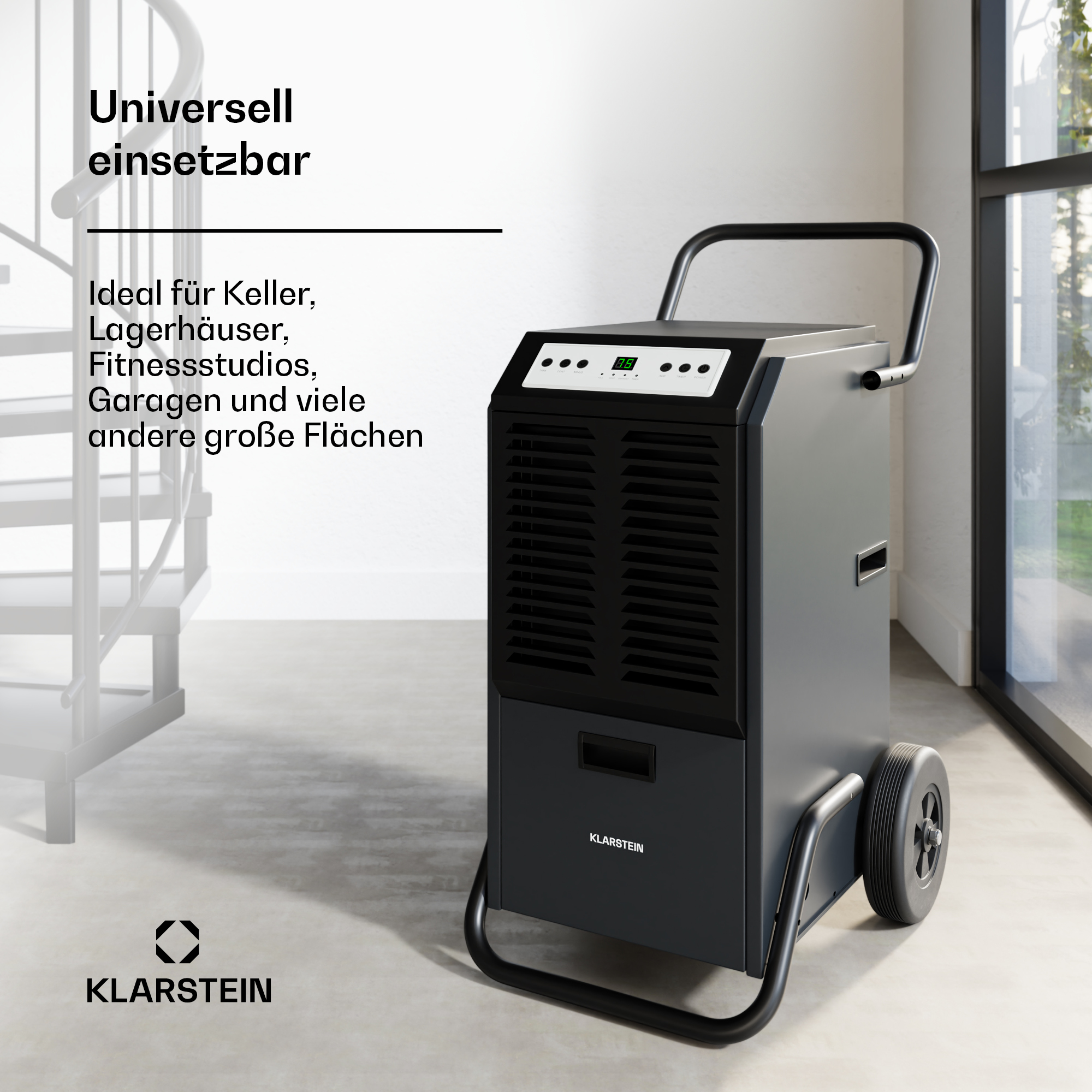 Ein schwarzer und grauer Luftentfeuchter mit Rädern, Griff und der Marke Klarstein, mit einer Metall-Wendeltreppe im Hintergrund.
