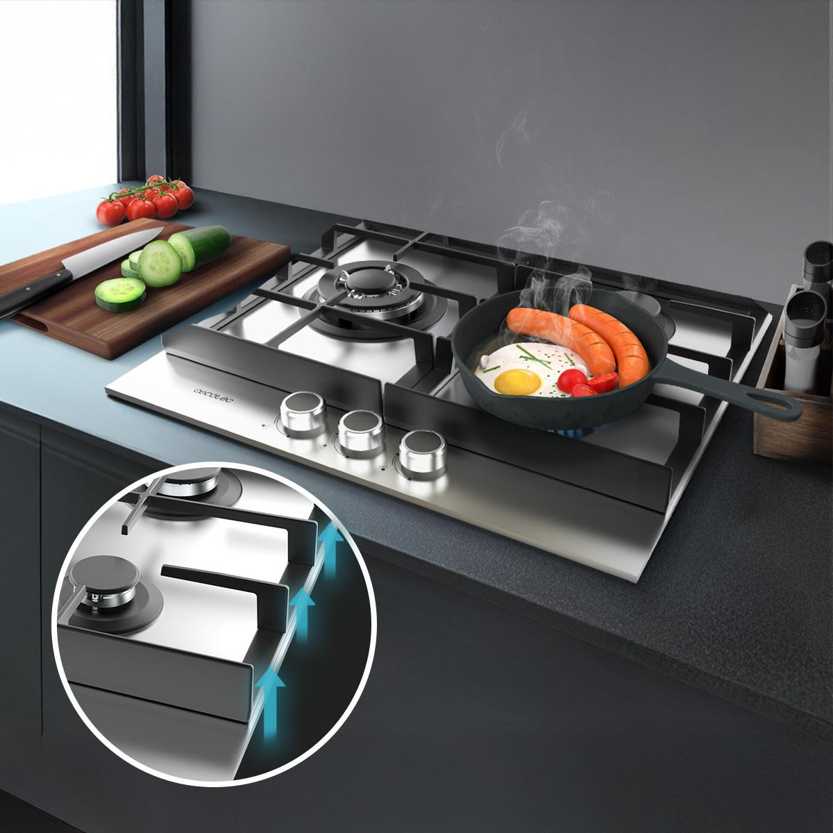 Płyta kuchenna ze stali nierdzewnej z patelnią zawierającą jajka i kiełbasę. Jest deska do krojenia z warzywami.