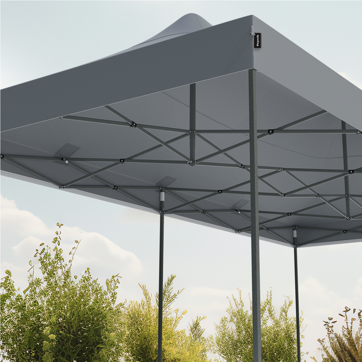 A close-up of a grey canopy tent from below, with the sky visible through the frame.