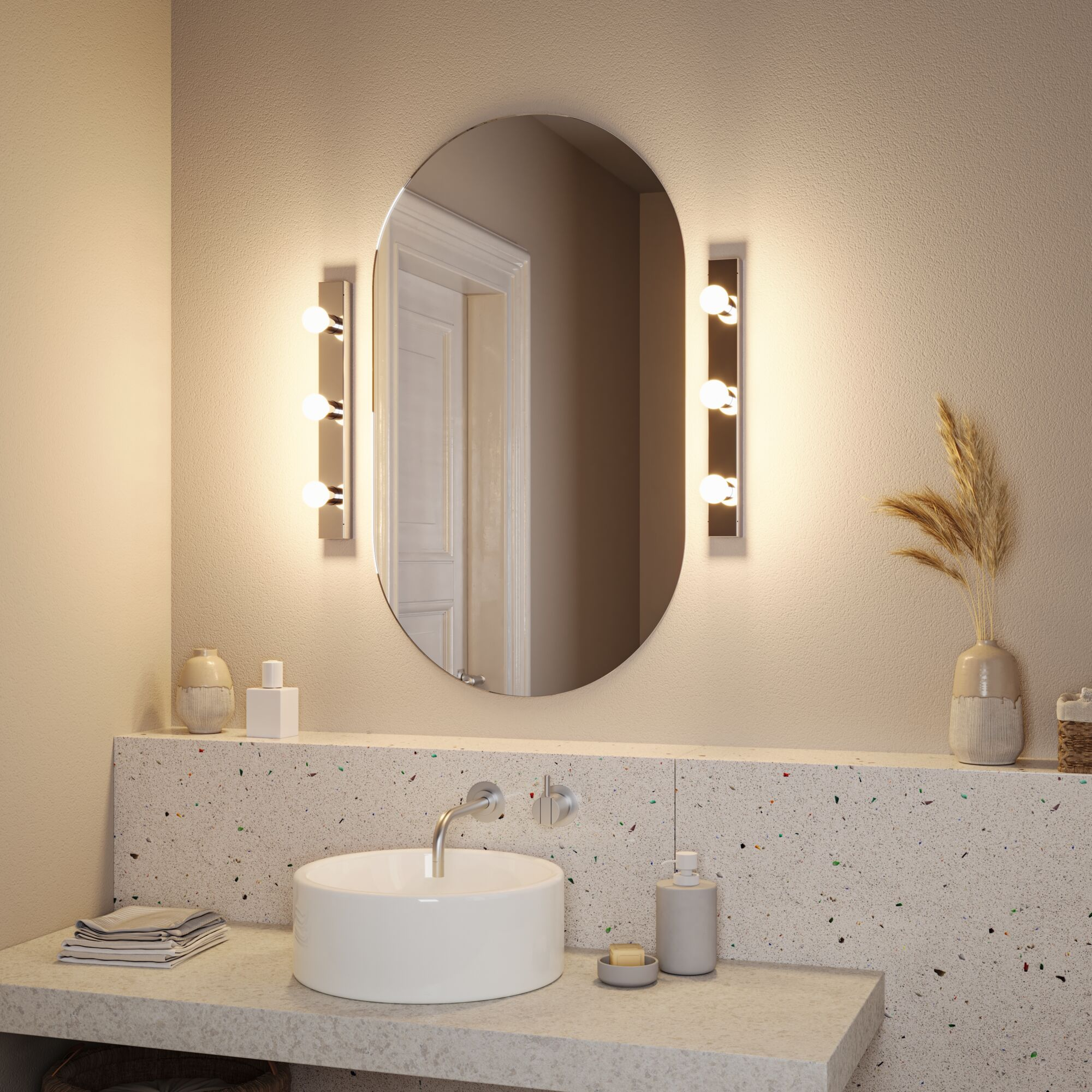 Łazienka z owalnym lustrem, oświetleniem, umywalką i blatem.