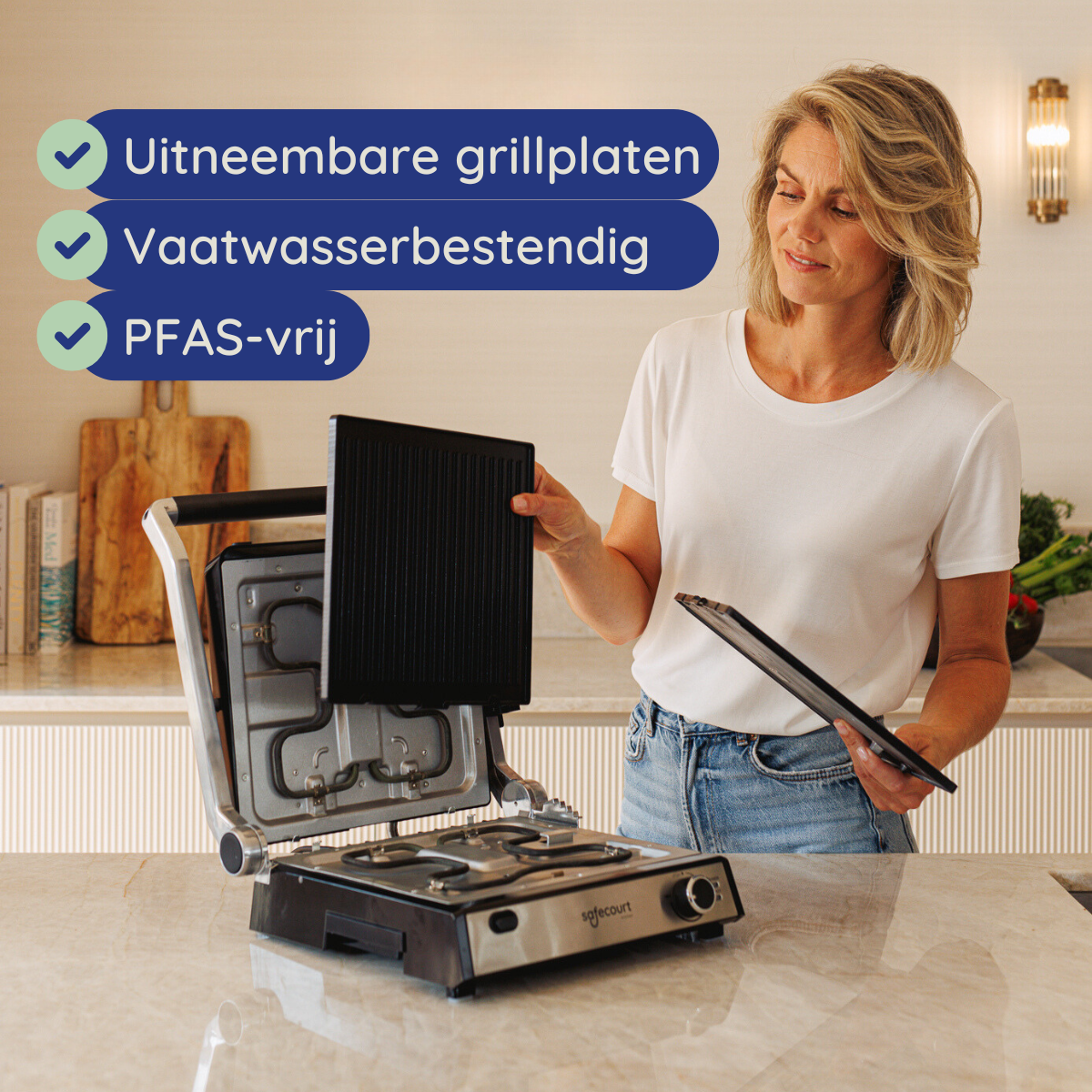 A woman holds a grill plate. The grill is on a countertop. Text lists removable plates, dishwasher safe, and PFAS-free.