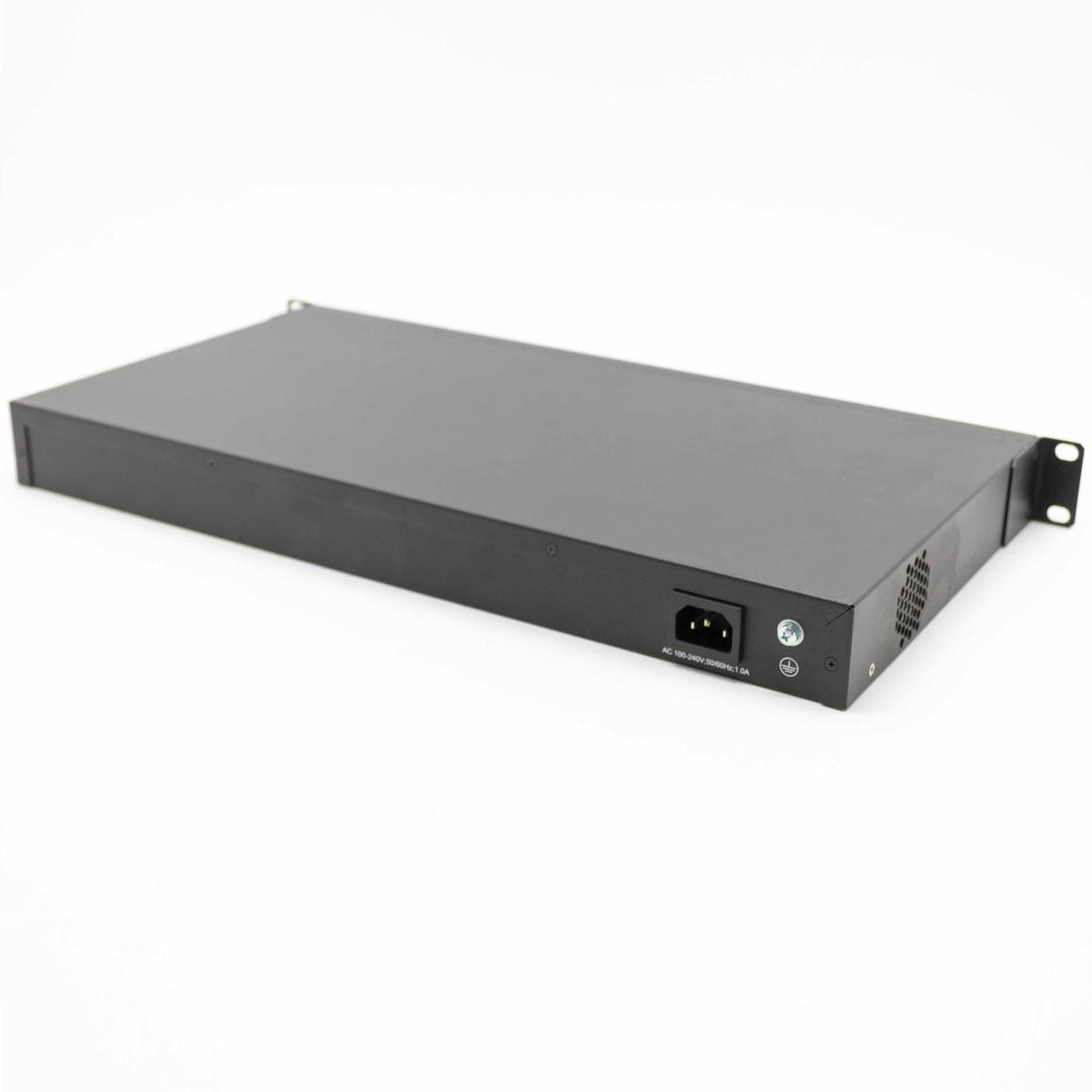 Czarne urządzenie elektroniczne, prawdopodobnie przełącznik sieciowy, na białej powierzchni, pokazujące porty i wejście zasilania.