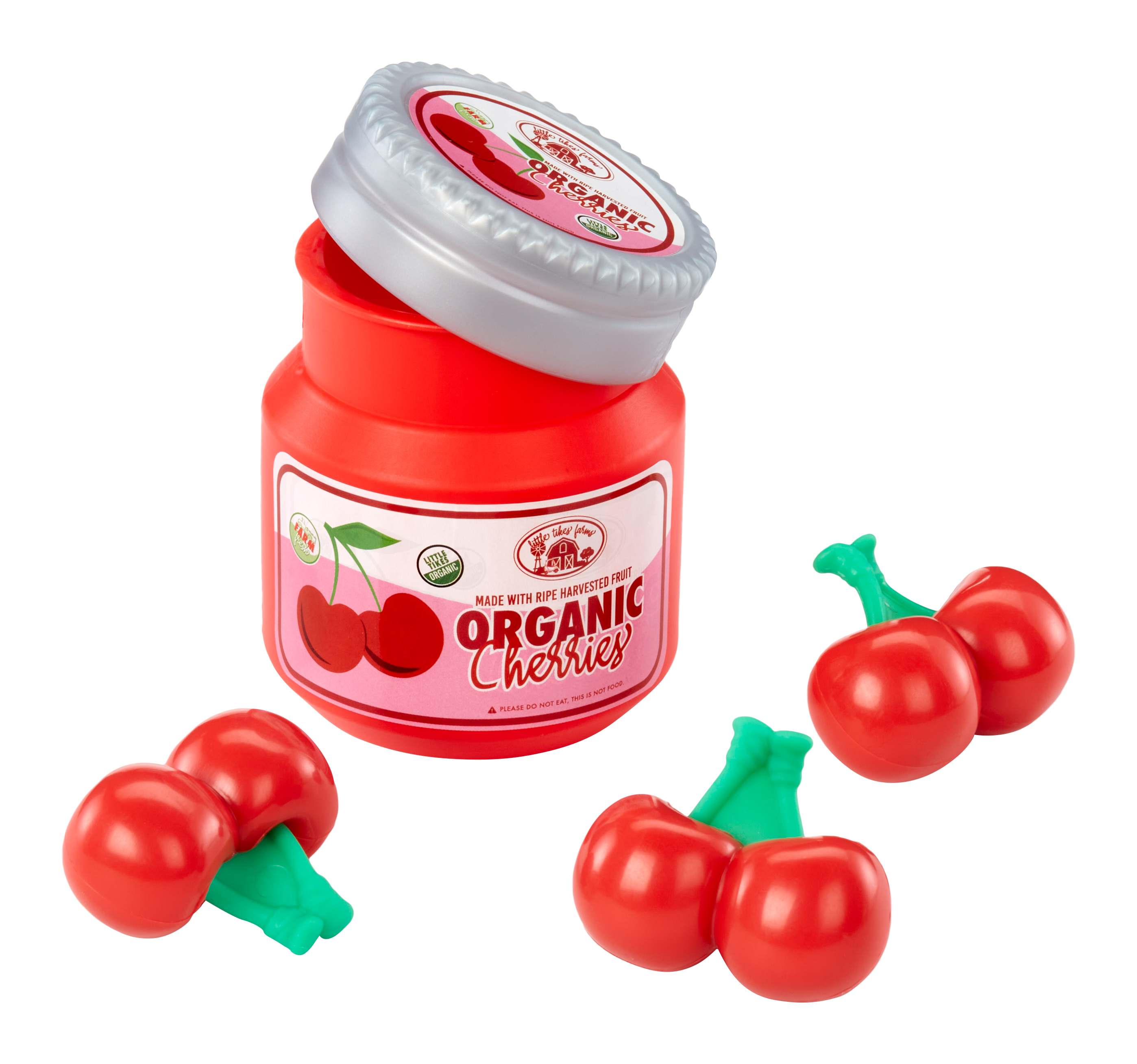 Rotes Glas mit Kirschen, daneben Kirschen. Grüne Stiele.