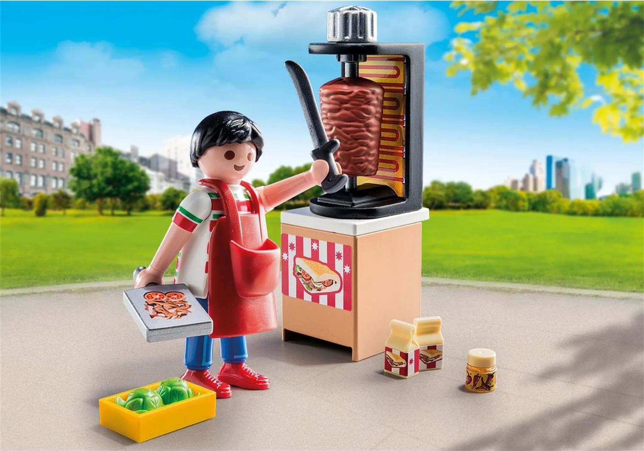 Playmobil-Set: Eine Figur mit einem Messer an einer Döner-Maschine, mit Essen und Zubehör.