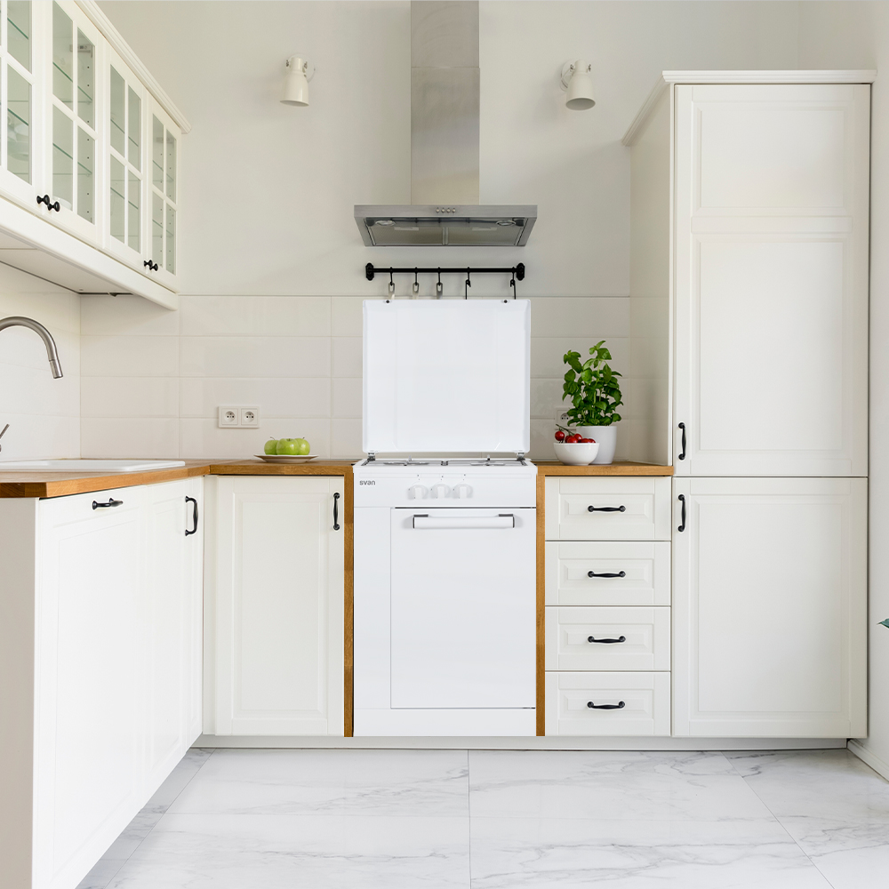Una cocina blanca con armarios blancos y un electrodoméstico blanco.