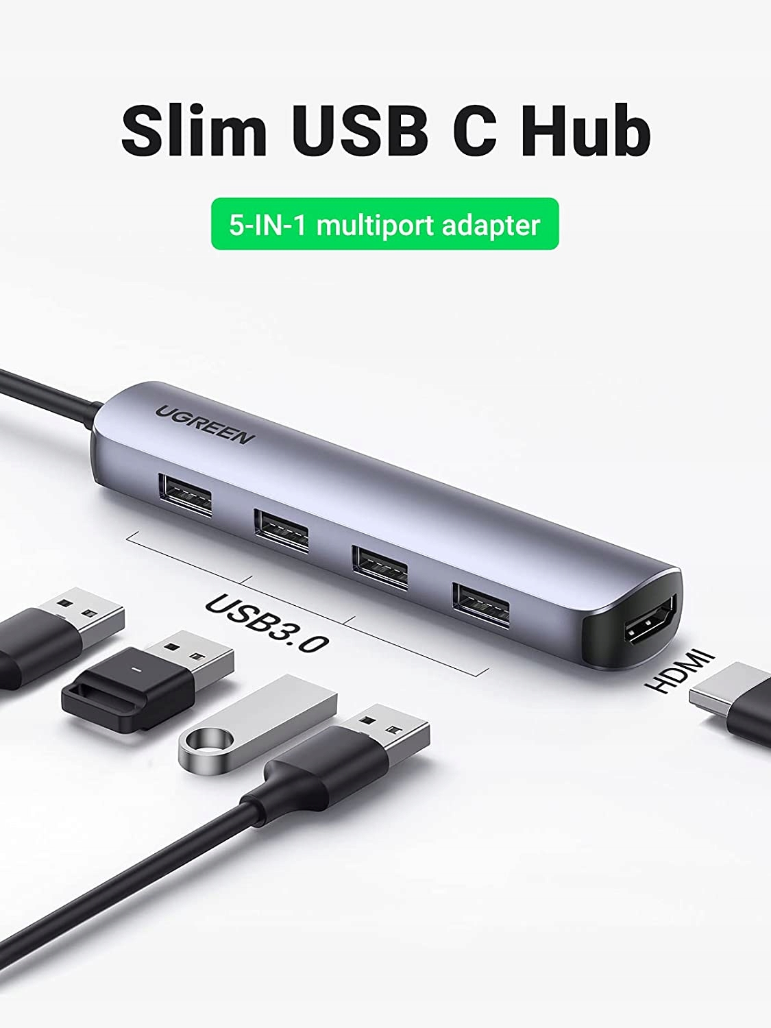 Srebrny hub USB-C z wieloma portami, w tym HDMI i USB 3.0, z kablami. Tekst: 'Slim USB C Hub'.