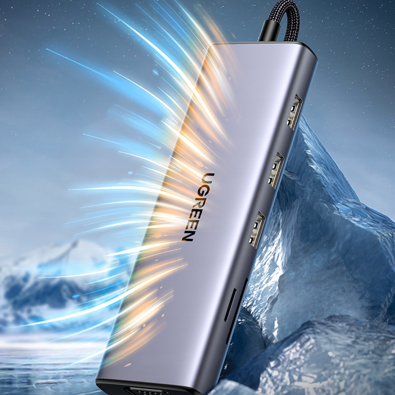 Srebrny hub UGREEN z wieloma portami. Znajduje się na tle niebiesko-białego lodowego tła ze smugami światła.