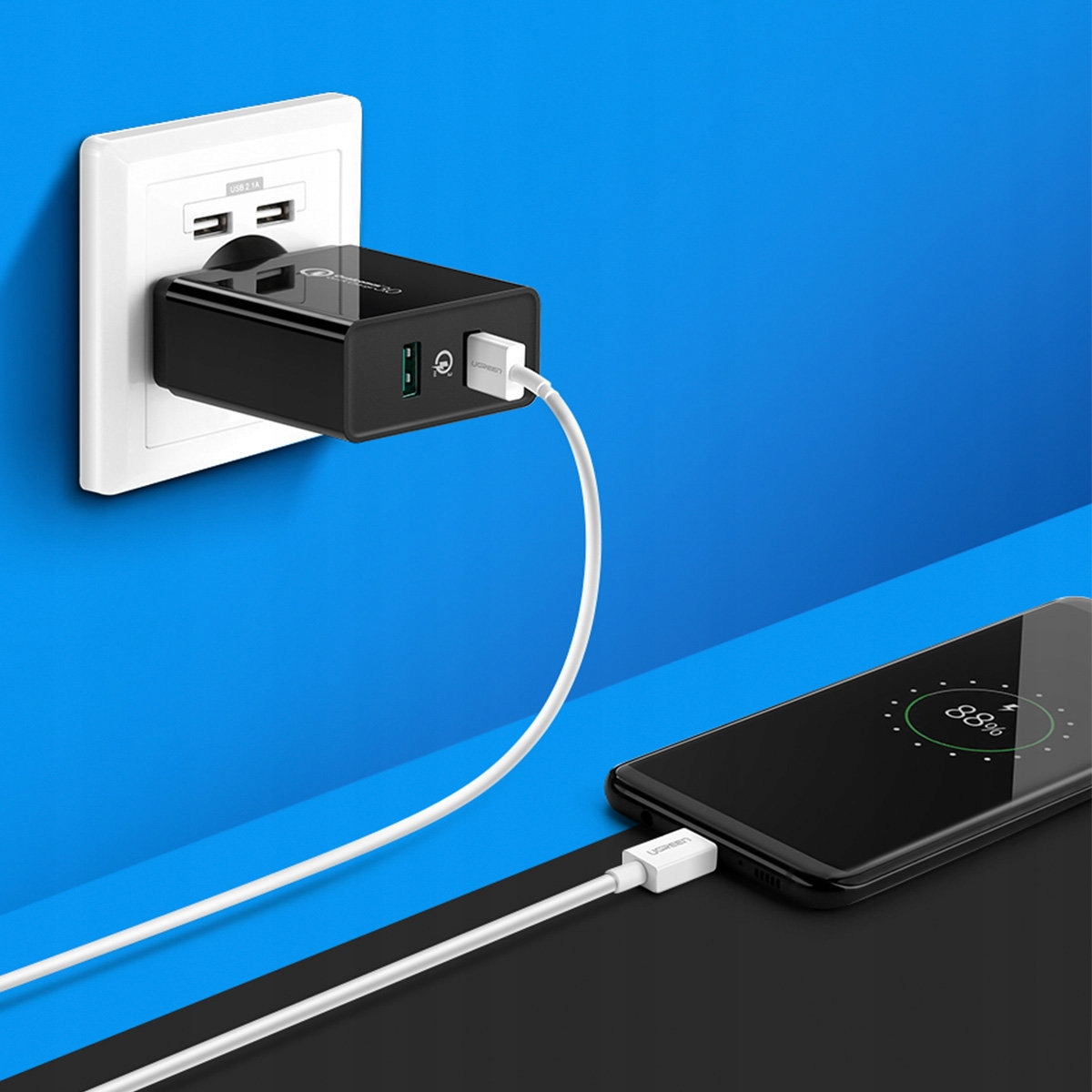 Ein schwarzer Netzadapter ist in eine Steckdose eingesteckt und lädt ein Telefon mit einem weißen Kabel auf.