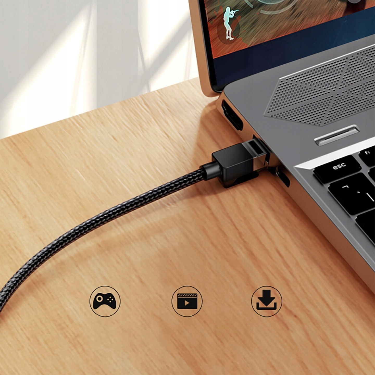 Kabel podłączony do laptopa z ikonami gier, wideo i pobierania.