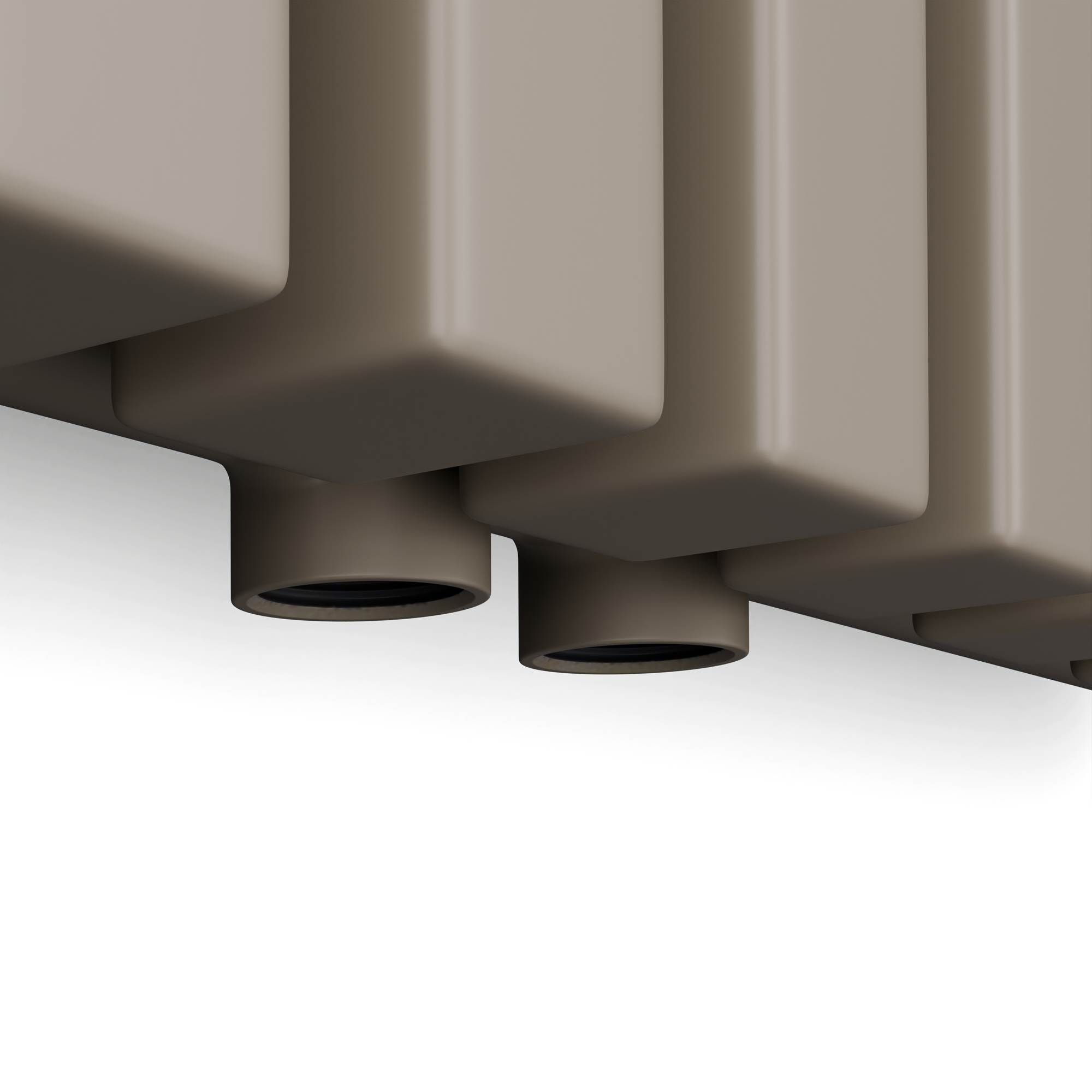 Primo piano di un elemento riscaldante rettangolare beige con due uscite cilindriche grigio scuro.