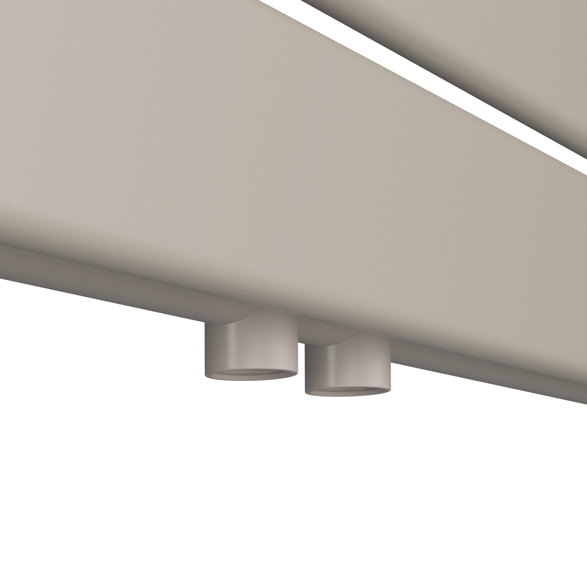 Primo piano di un elemento riscaldante rettangolare beige con due uscite cilindriche bianche.