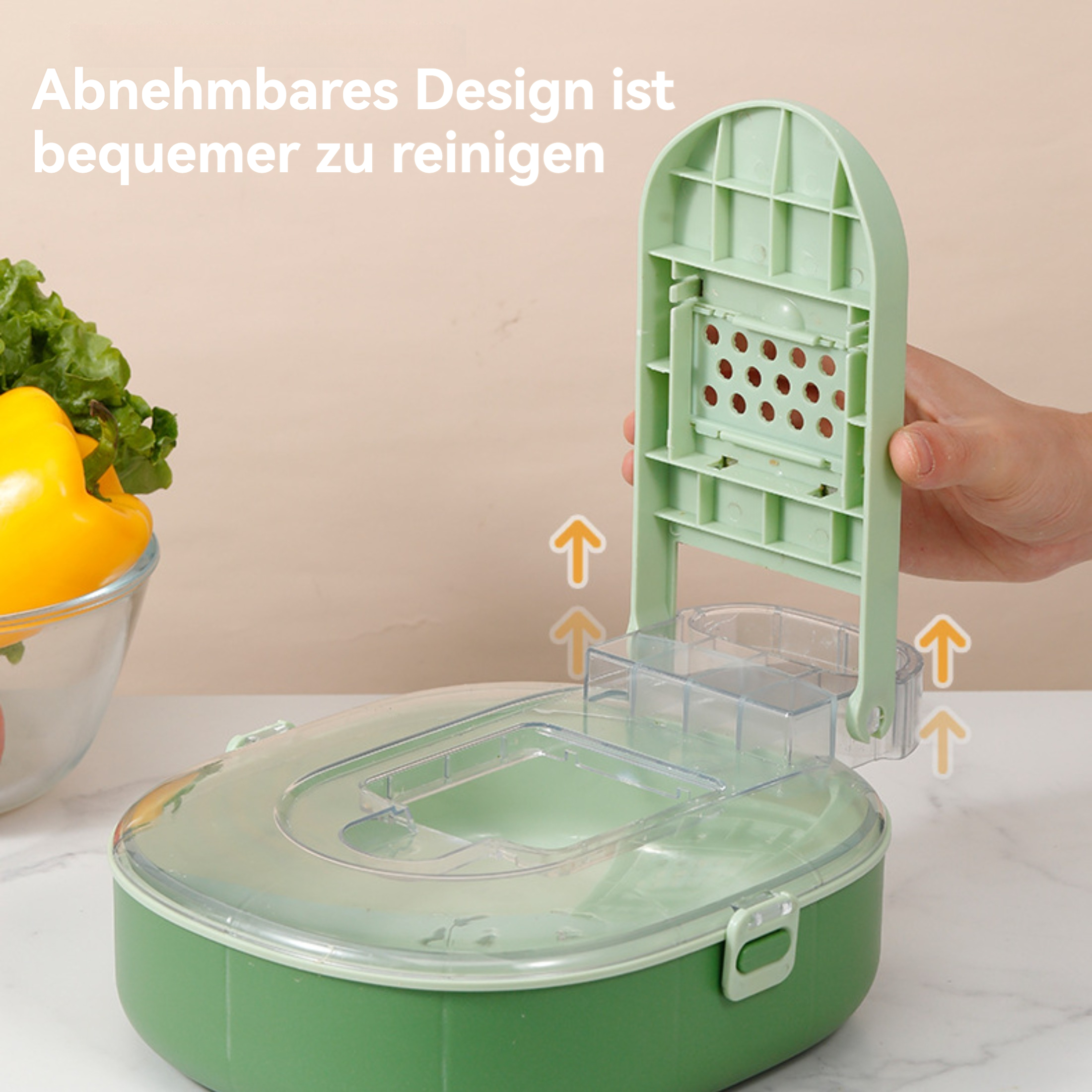 Ein grüner Behälter mit Klappdeckel ist geöffnet. Gemüse ist in einer Schüssel. Pfeile zeigen auf den Deckel. Text sagt leicht zu reinigen.