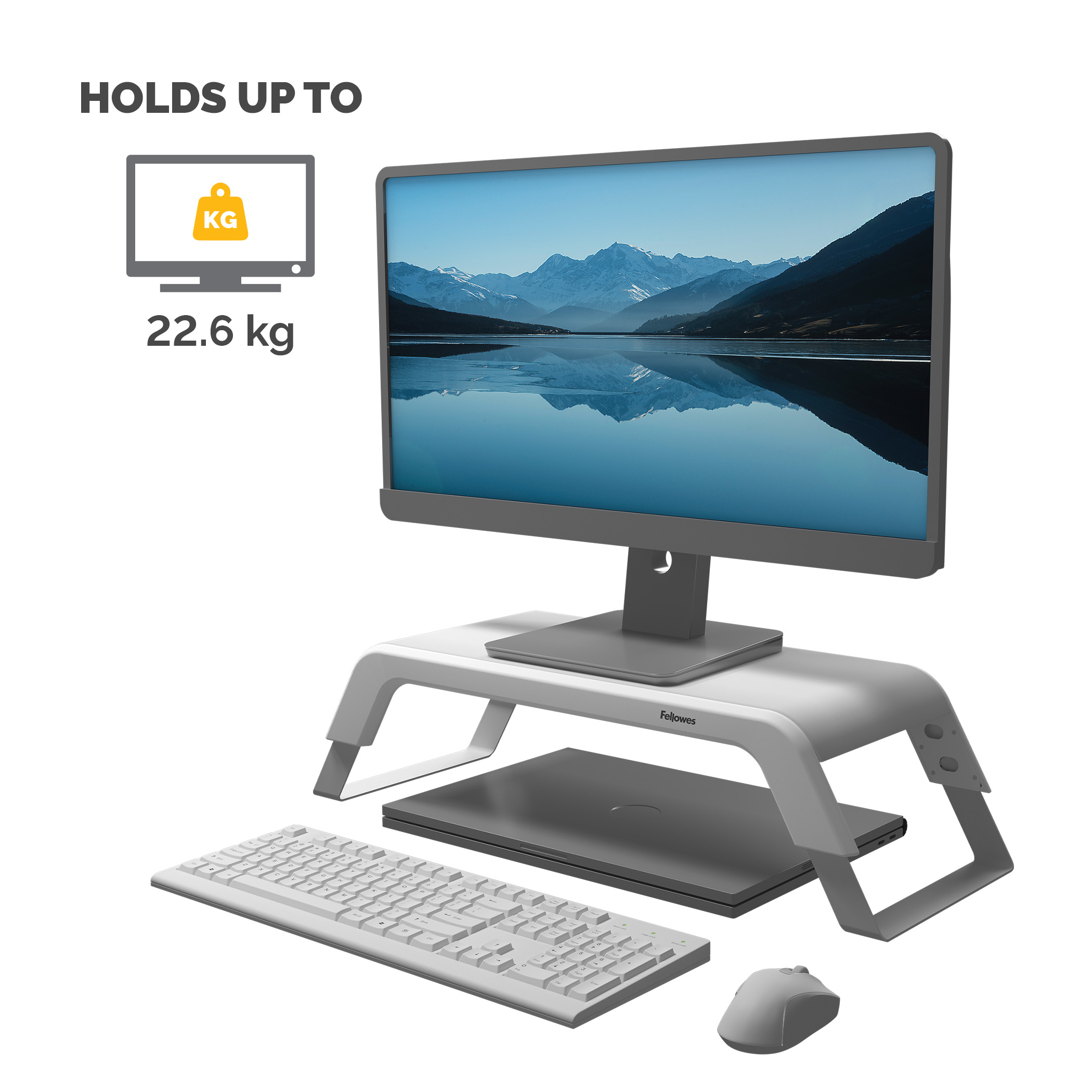 Ein Computermonitor auf einem weißen Ständer mit Laptop, Tastatur und Maus. Text zeigt die Tragfähigkeit.
