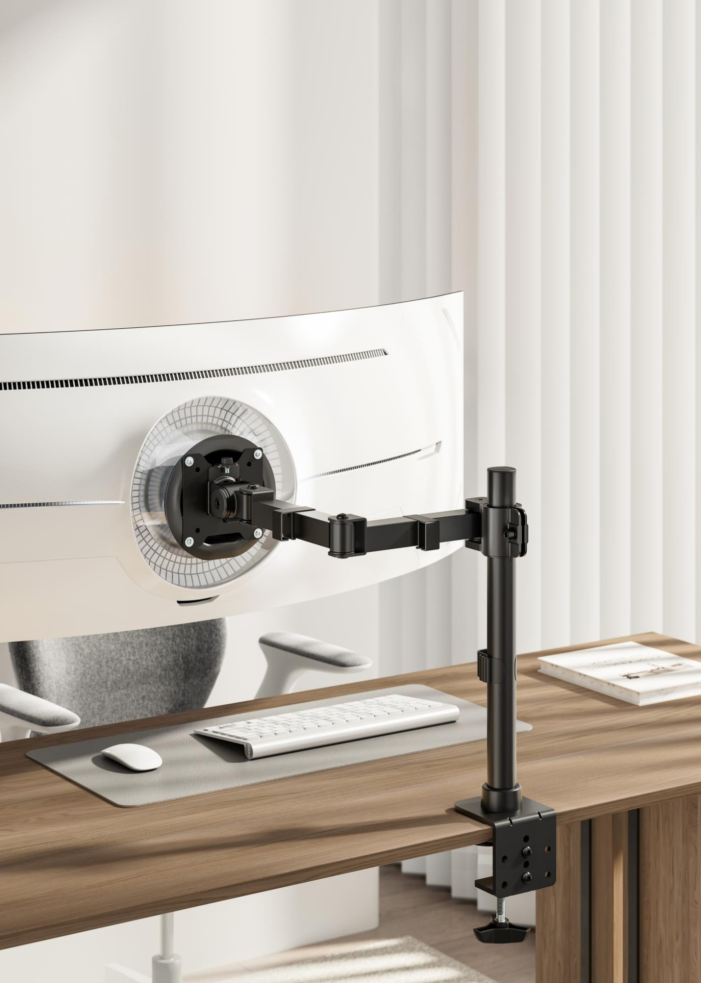 Monitor mounted on a desk with a keyboard and mouse. White curtains are in the background.