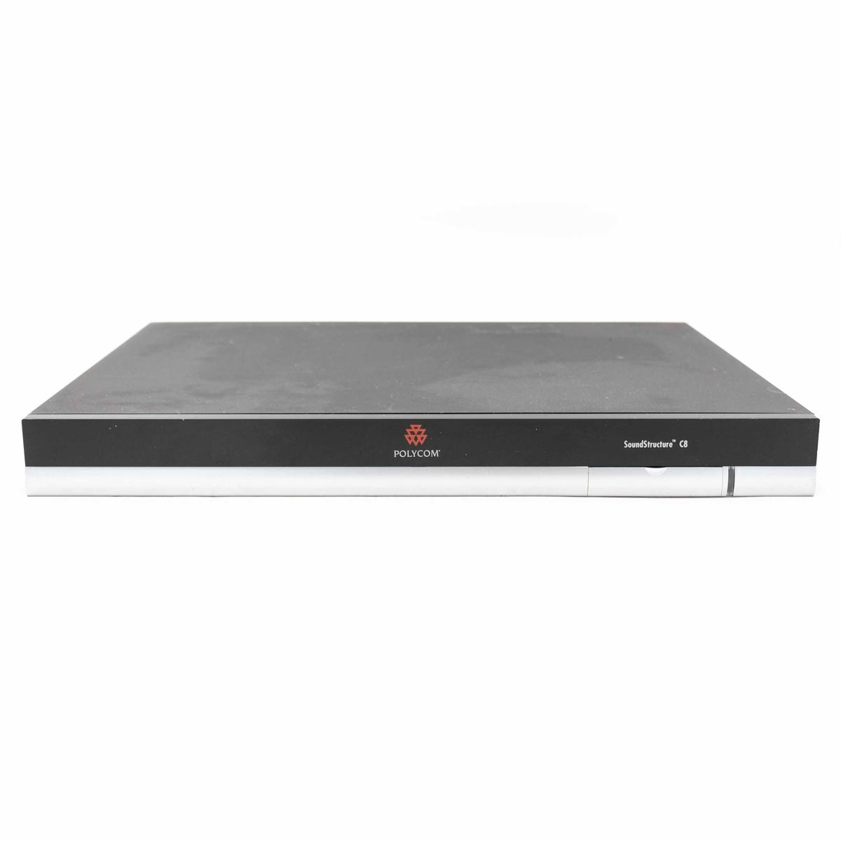Un dispositivo rettangolare nero con 'POLYCOM' stampato sul davanti. Il dispositivo ha una base argentata e sfondo bianco.