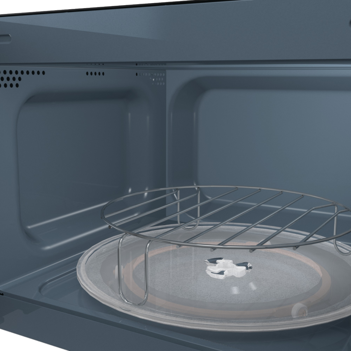 All'interno di un forno a microonde. Sono visibili un piatto di vetro e una griglia metallica. L'interno è blu.