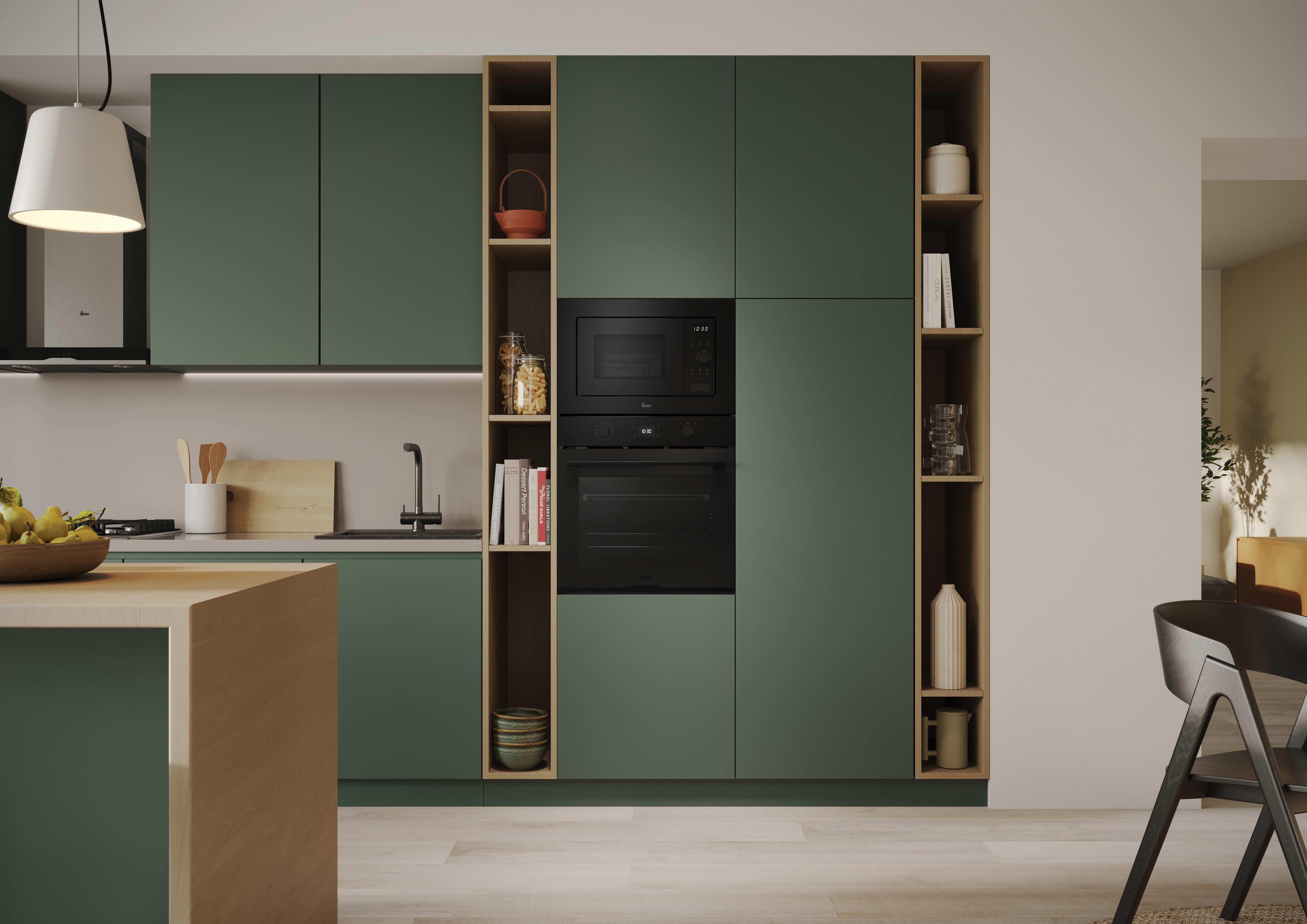 Una cocina moderna con gabinetes verdes y un microondas y horno negro. Se ven detalles y estanterías de madera.