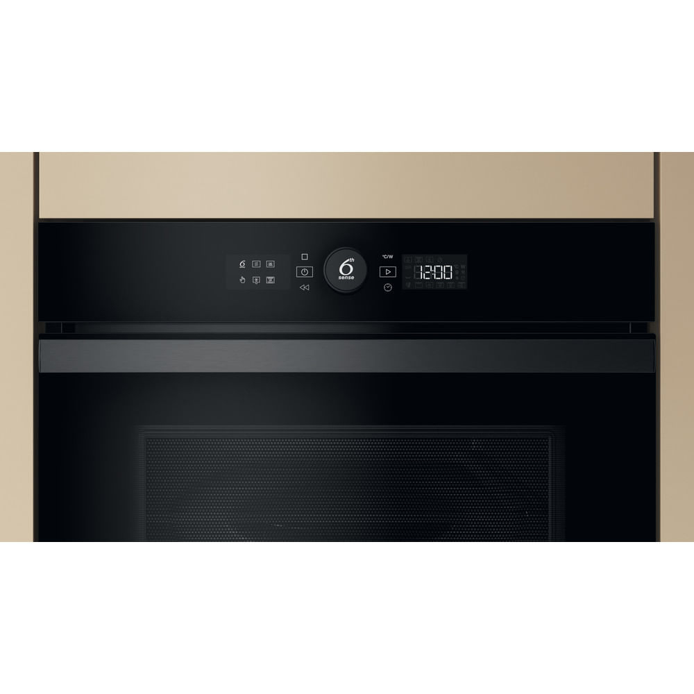 Un primer plano del panel de control de un horno microondas. Tiene una pantalla digital y botones de control.