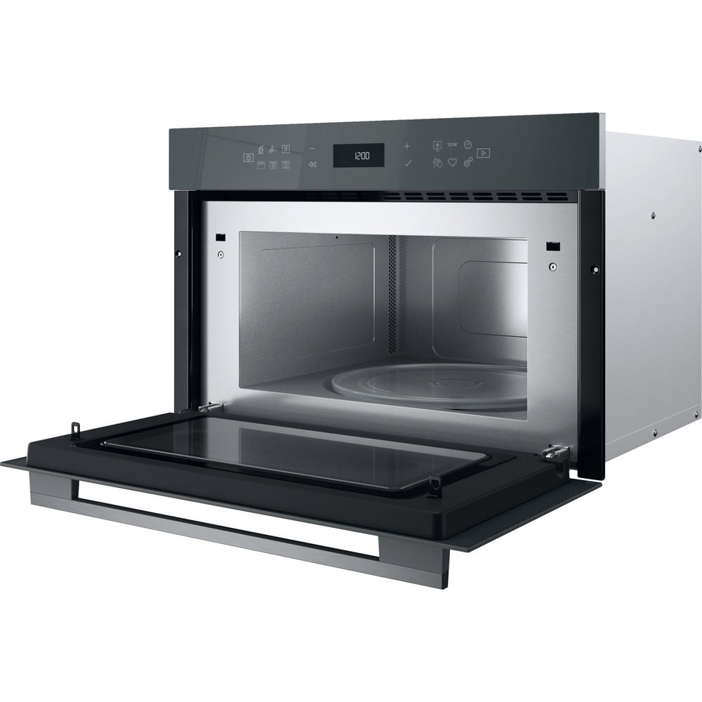A gray microwave oven with an open door. The interior is visible. The time 12:00 is displayed on the oven.