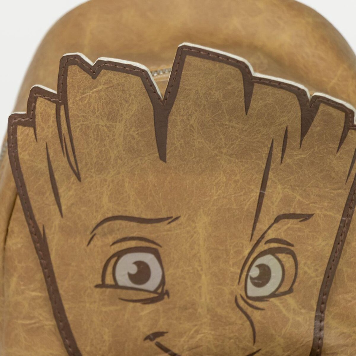 Primer plano de una bolsa marrón de Groot. La cara es visible. Tiene una expresión amigable.