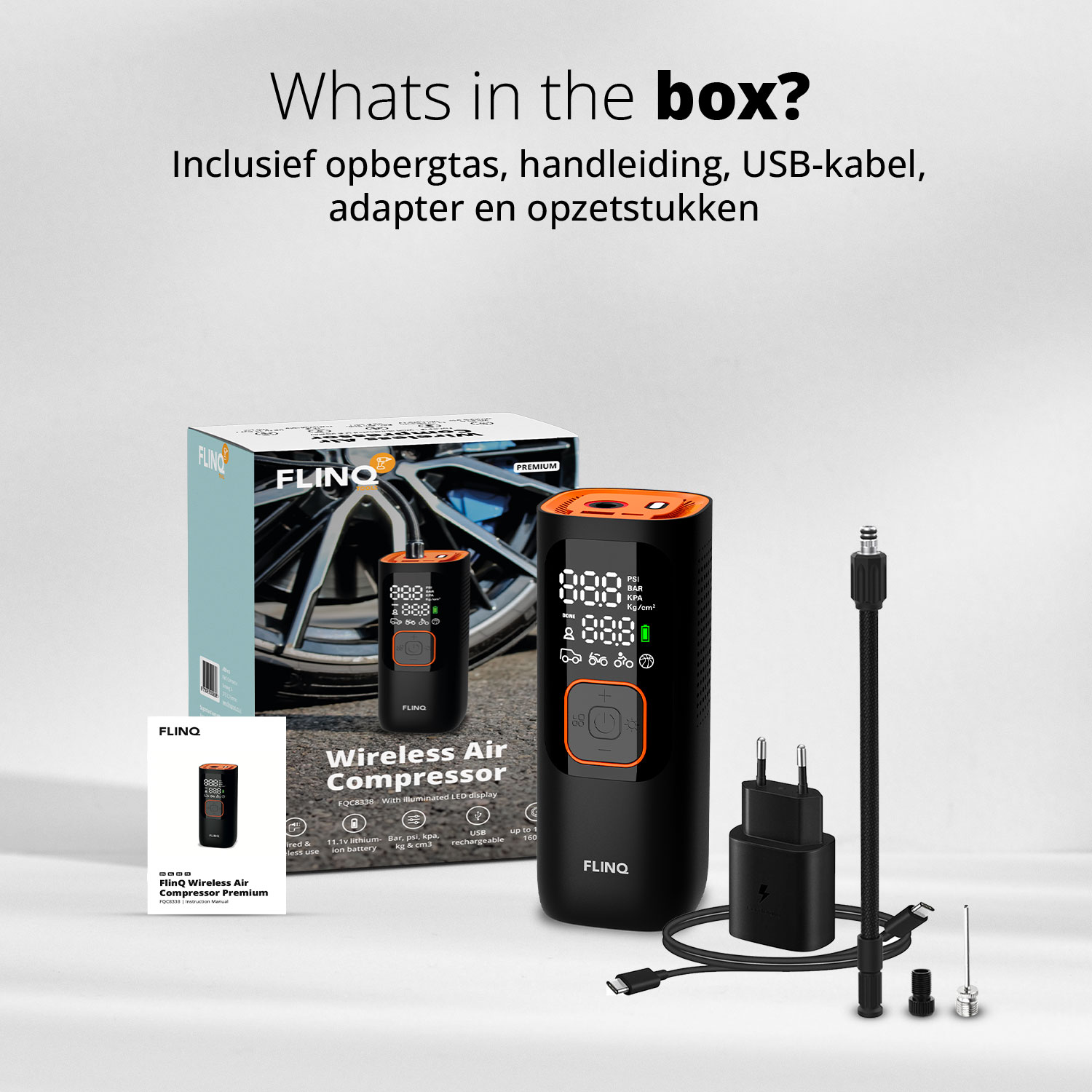 Afbeelding toont een doos met een luchtcompressor, een pomp, een oplader en accessoires. De doos en de compressor zijn zwart en oranje.