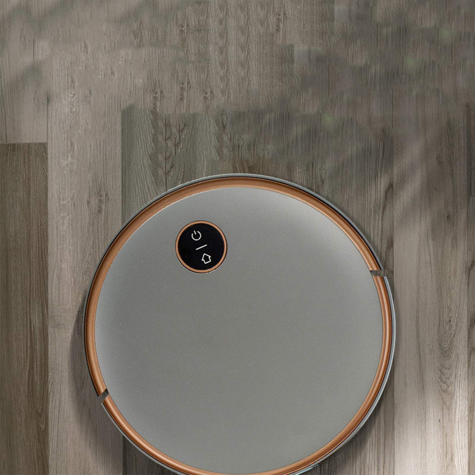 Ein runder Roboter-Staubsauger auf einem Holzboden mit einem Ein-/Ausschalter.