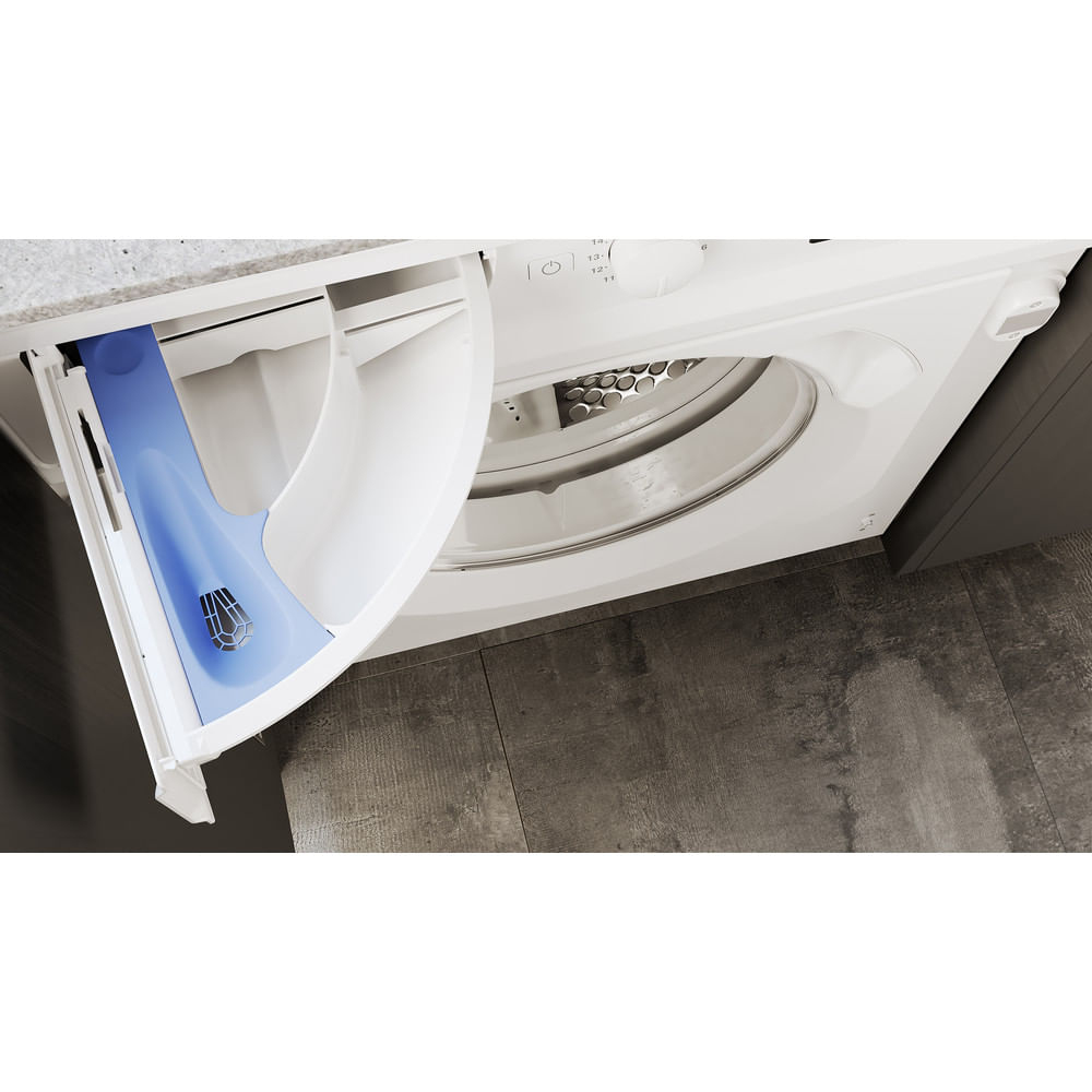 A white washing machine drawer is open, showcasing a blue detergent compartment, inside a gray and white room.