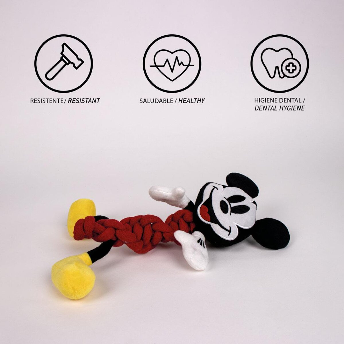 Mickey Mouse Spielzeug mit rotem Seil, weißen Handschuhen und gelben Füßen. Drei Symbole oben: Hammer, Herz, Zähne.