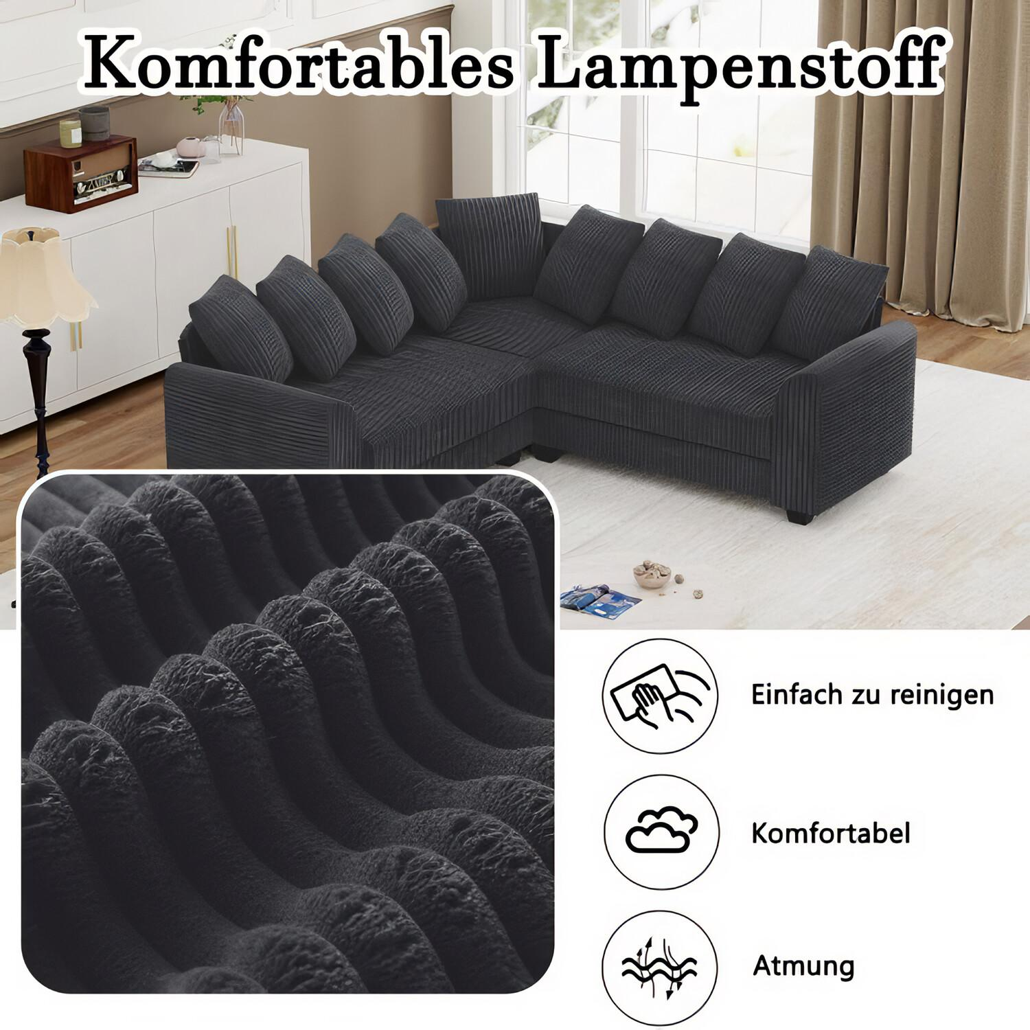 Nahaufnahme eines dunkelgrauen Cordstoffs mit Sofa im Hintergrund.