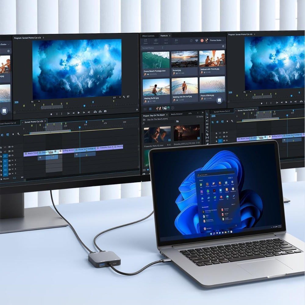 Ein Laptop, der über einen Hub mit zwei Monitoren verbunden ist. Zeigt eine Videoschnittstelle auf den Bildschirmen.