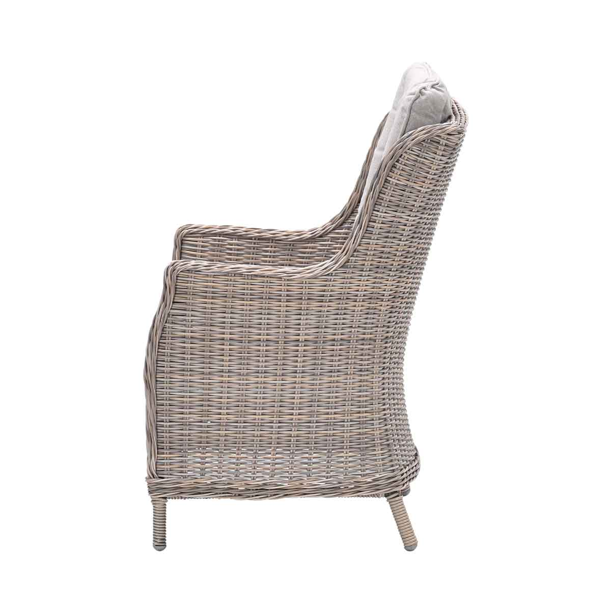 Side view of a gray wicker chair with a gray cushion and a white background.