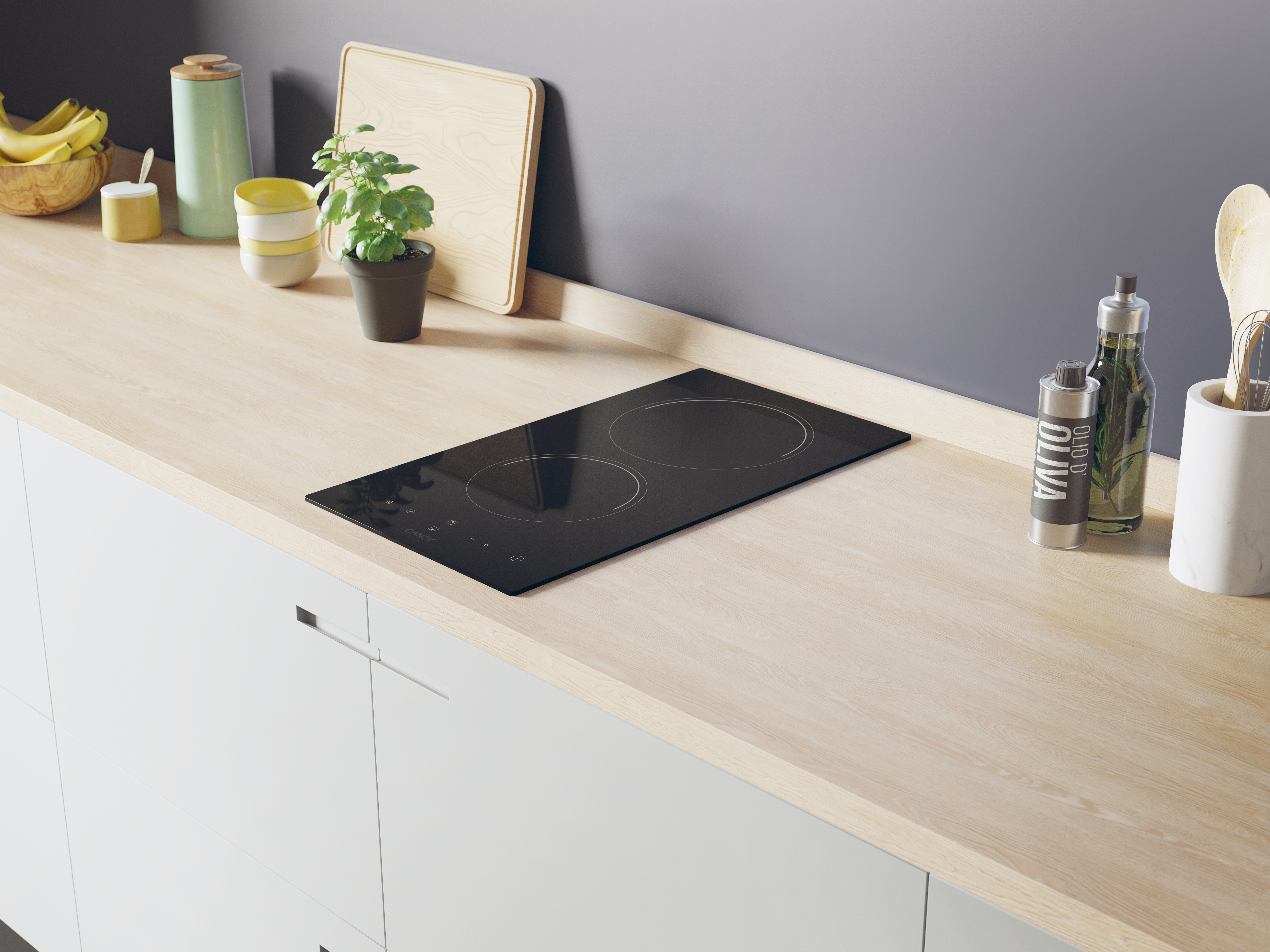 Scena kuchenna z czarną płytą grzewczą zamontowaną na jasnym drewnianym blacie, inne przedmioty na nim.