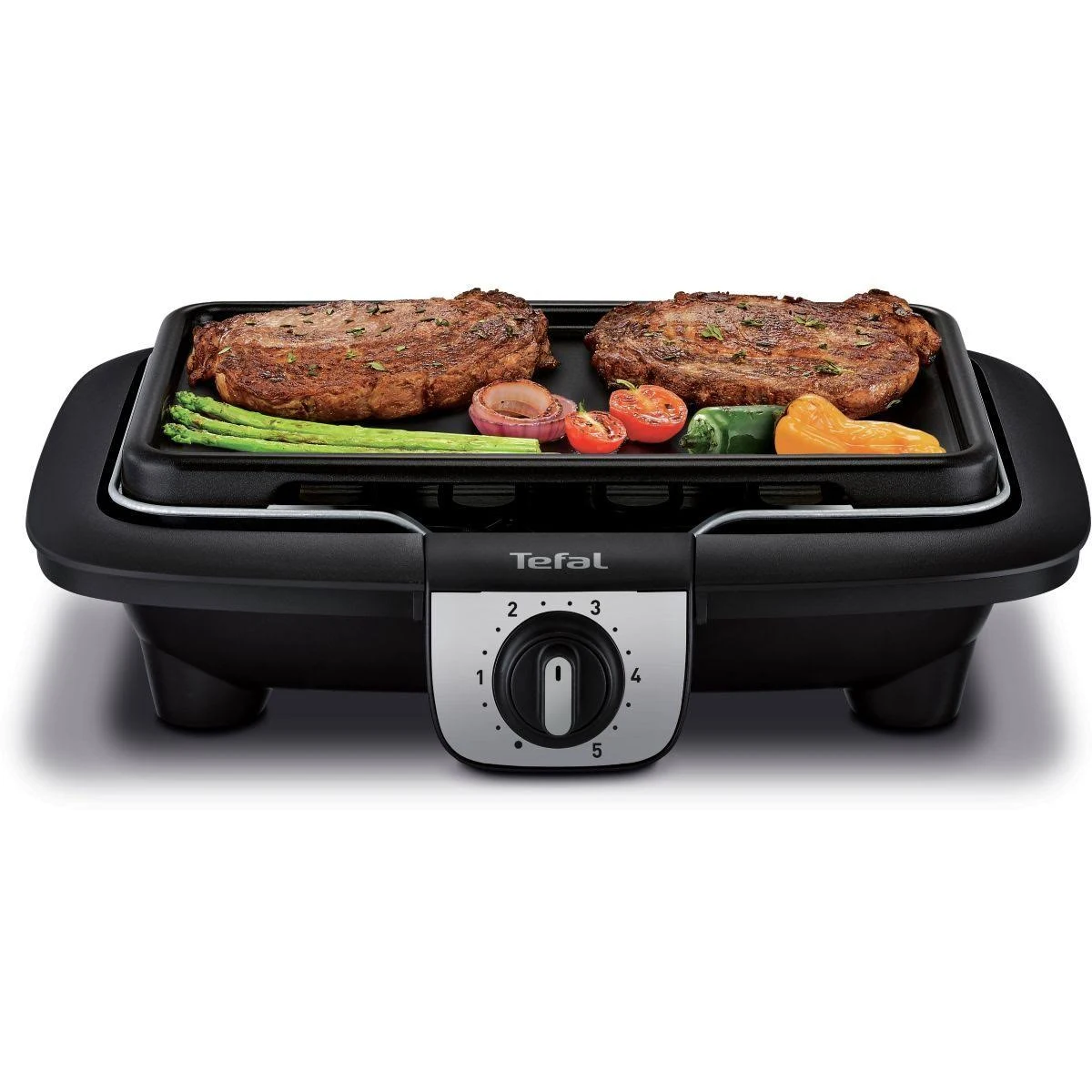 Griglia elettrica Tefal nera con due bistecche, verdure e manopola di controllo della temperatura.