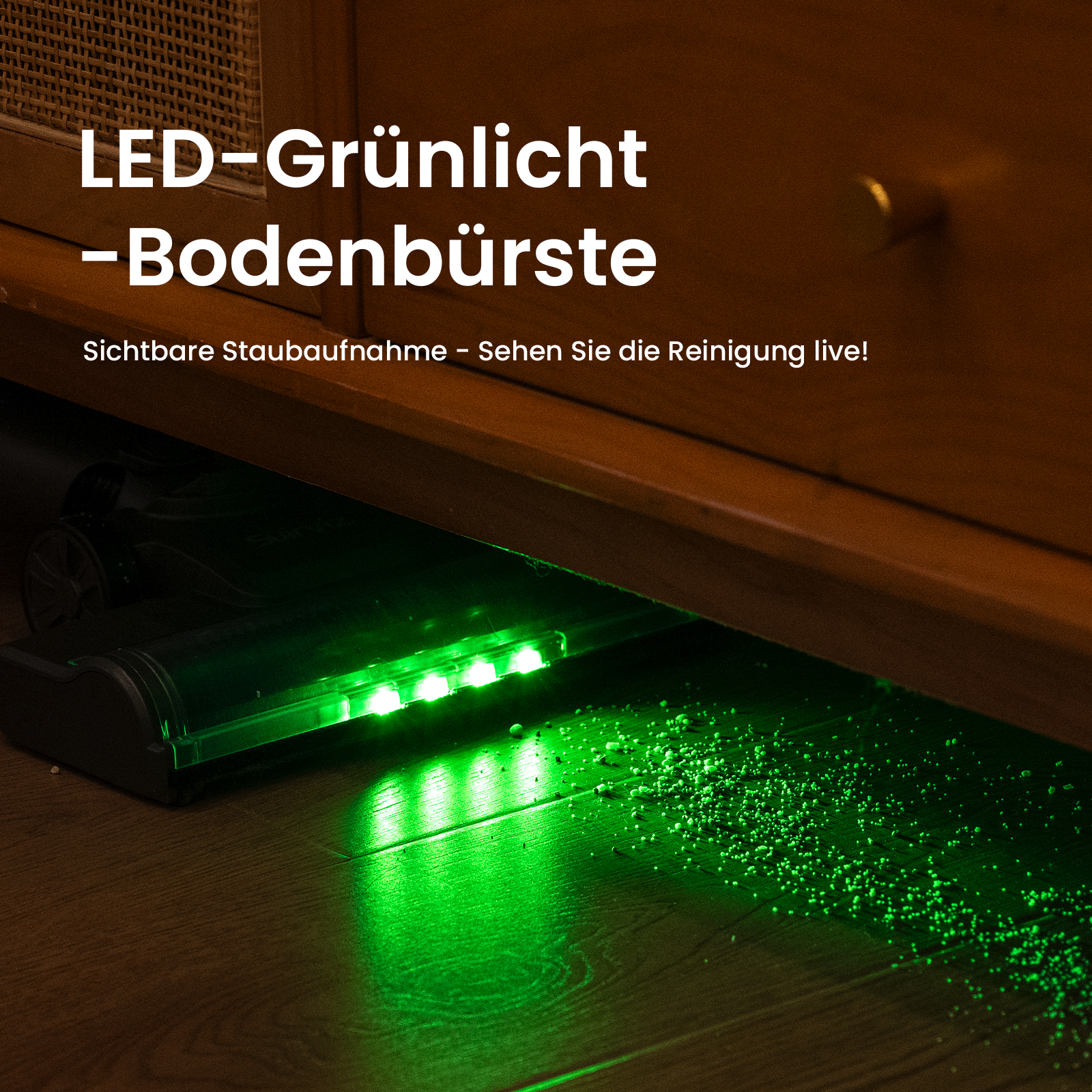 Głowica odkurzacza pod szafką, świecąca zielonym światłem na podłogę.