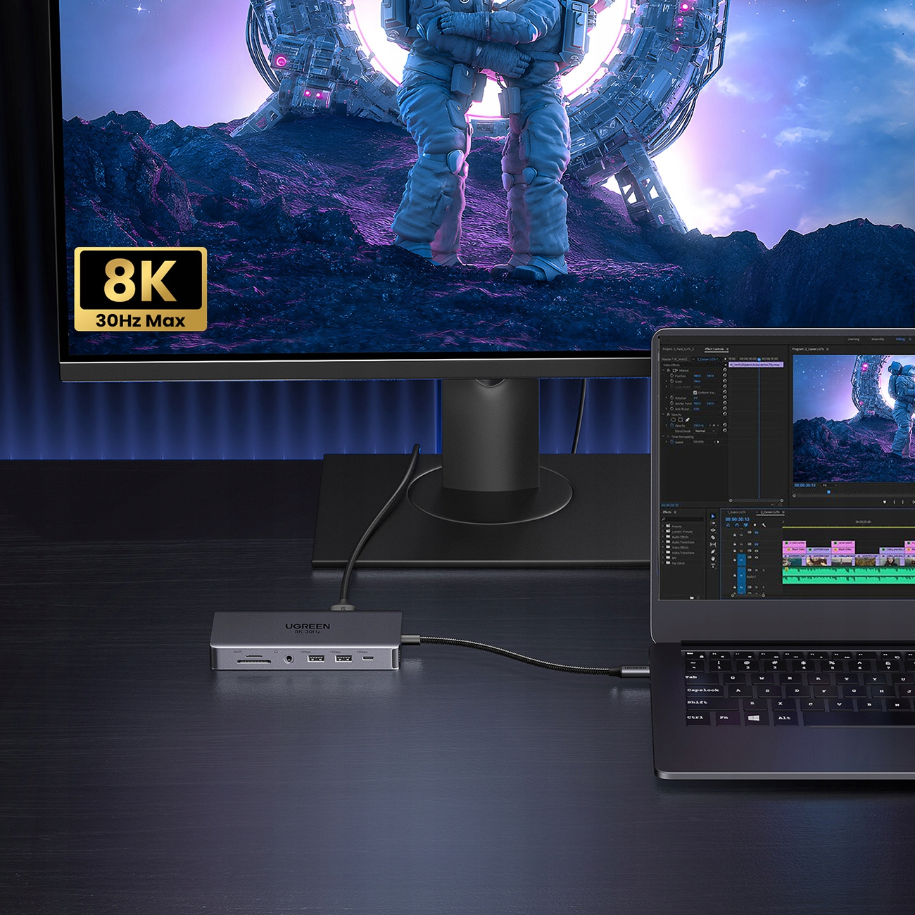 Monitor z obrazem astronauty, laptopem i hubem podłączonym do biurka. Wyświetlane są 8K i 30Hz Max.