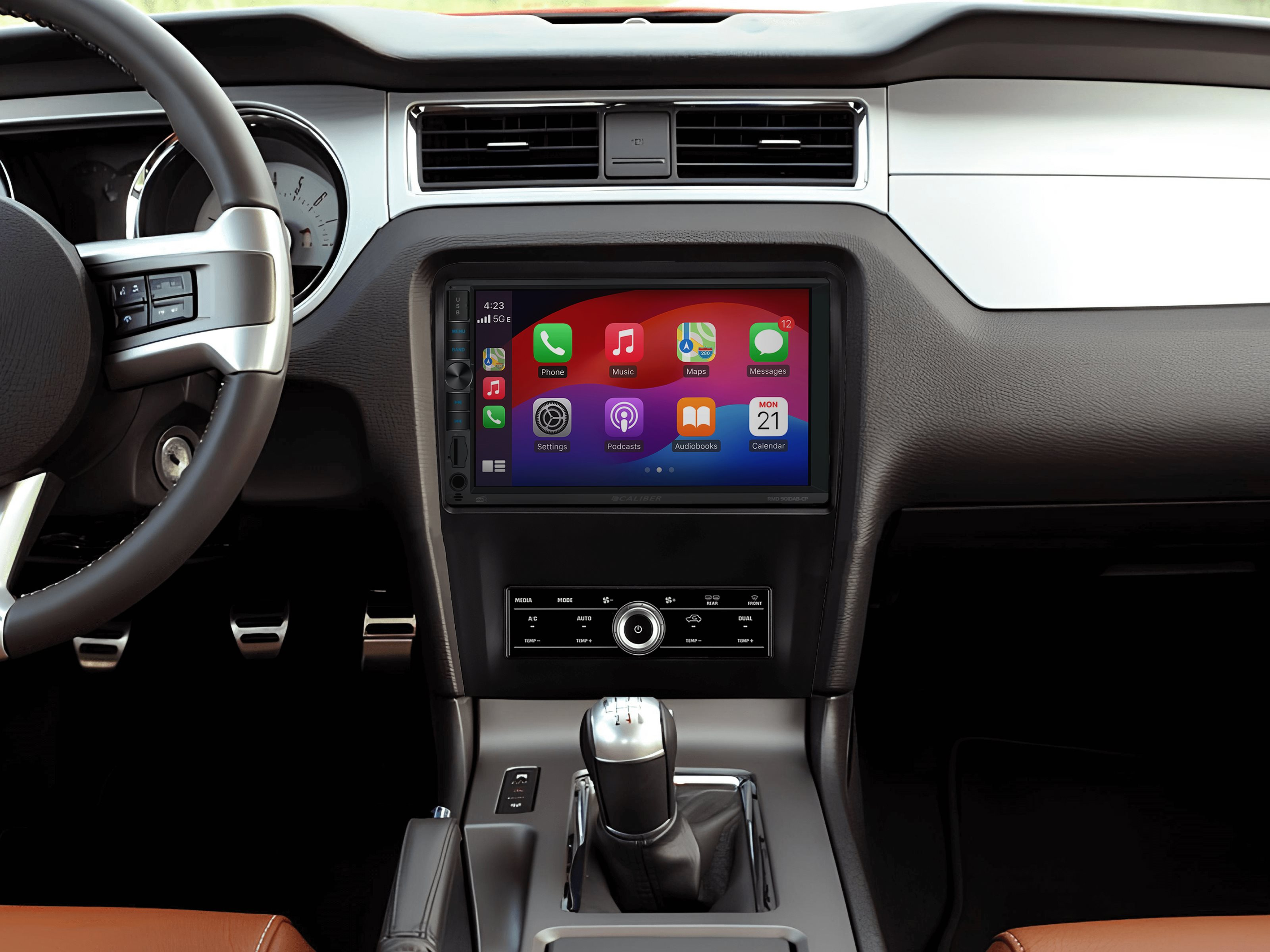 Car interior with a car radio, with a phone display, and other app icons shown on its screen.