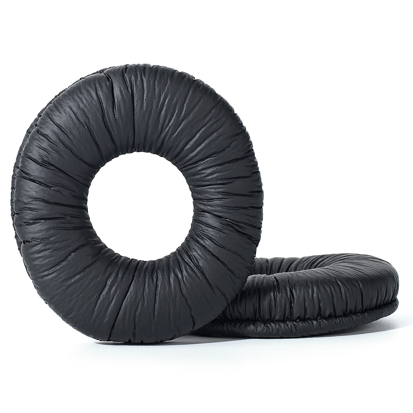 Due cuscinetti auricolari neri e rotondi. I cuscinetti sono in materiale morbido e strutturato.