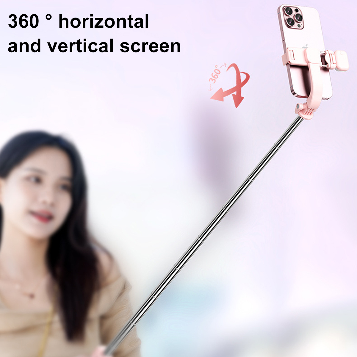 Ein Selfie-Stick mit einem befestigten Telefon. Das Telefon ist rosa. Der Stick ist silber. Der Hintergrund ist unscharf.