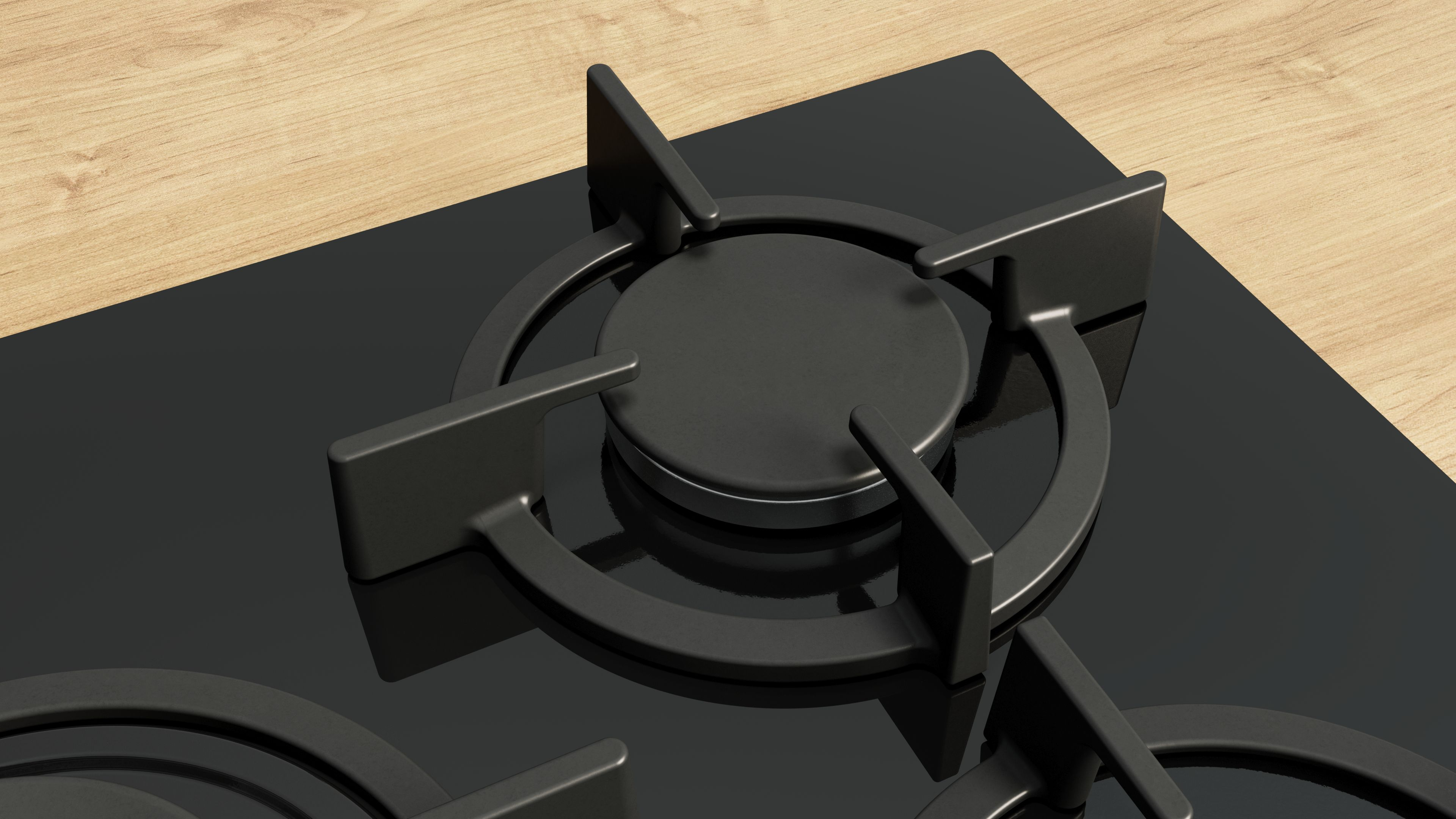 Primer plano de una cocina de gas negra con dos quemadores. Las rejillas de los quemadores son visibles.