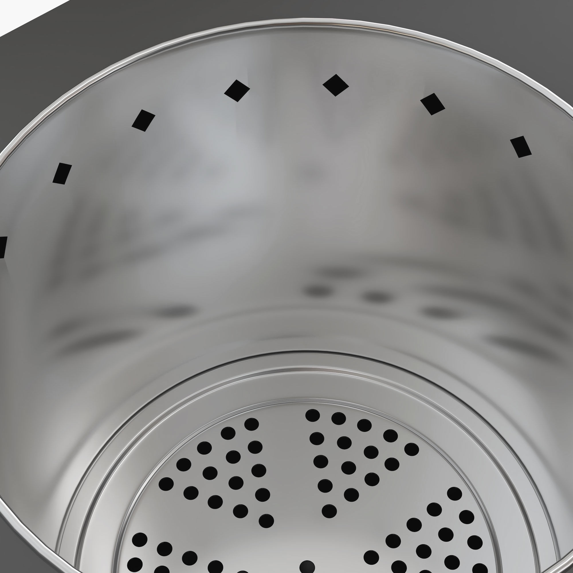 Innenansicht eines silbernen Metallbehälters mit perforiertem Boden.