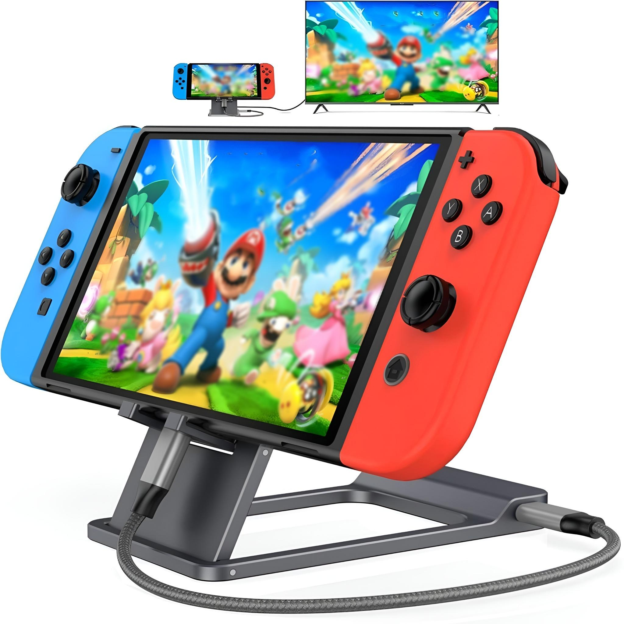 Eine Nintendo Switch mit roten und blauen Controllern, verbunden mit einem Ständer und einem Bildschirm, der Mario zeigt.