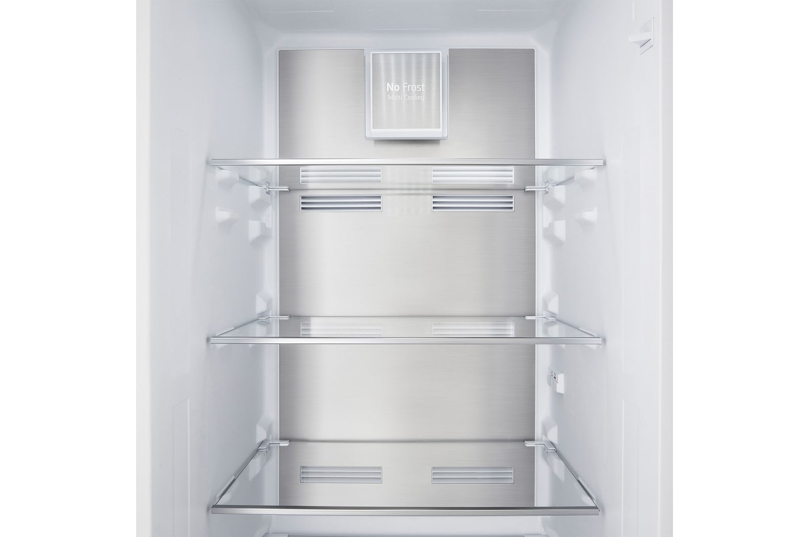 Wnętrze lodówki z szklanymi półkami i panelem tylnym ze stali nierdzewnej, oznaczonym jako 'No Frost'.