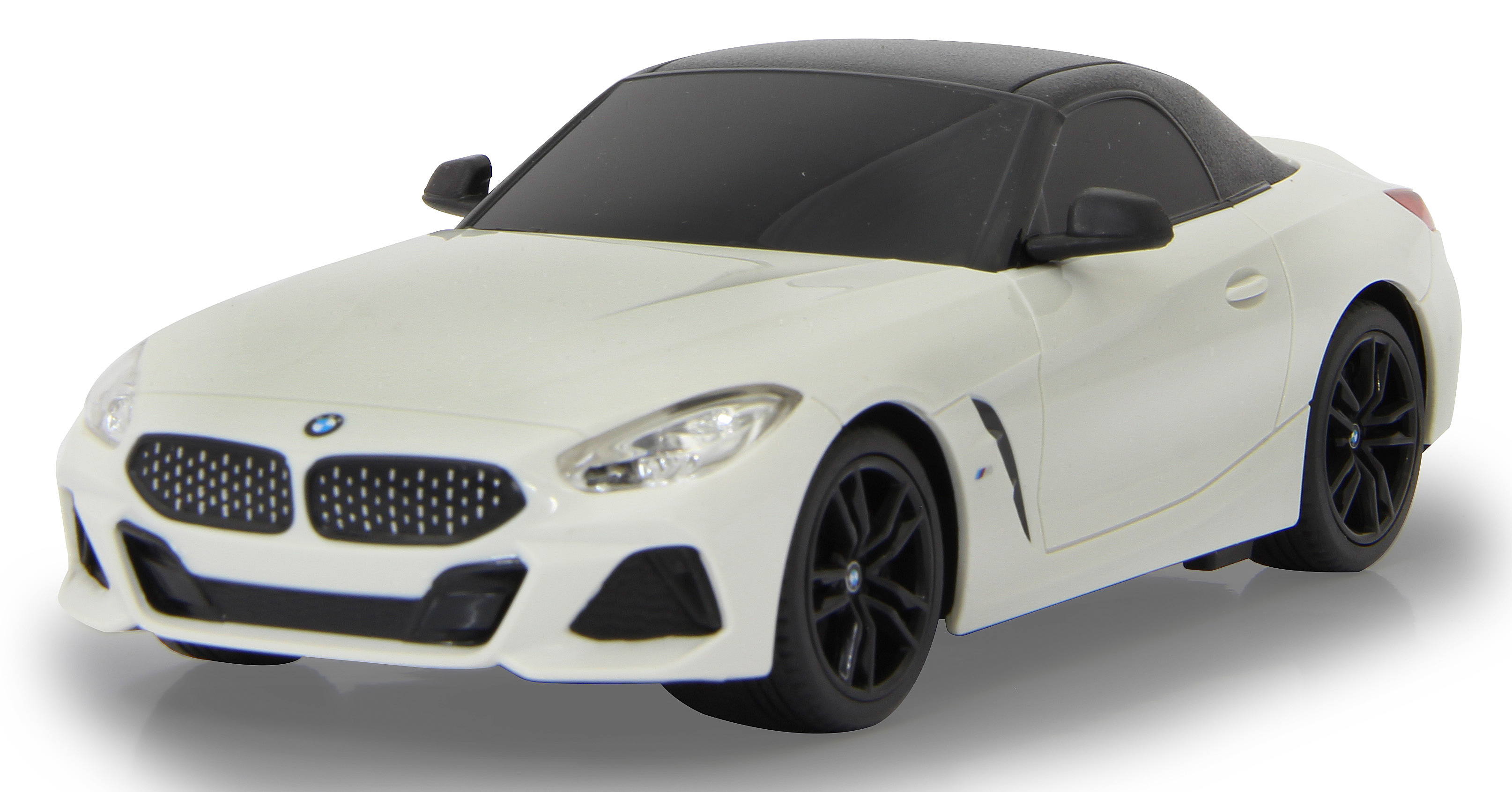 Ein weißes BMW Z4 Roadster Spielzeugauto mit schwarzem Dach und schwarzen Rädern.