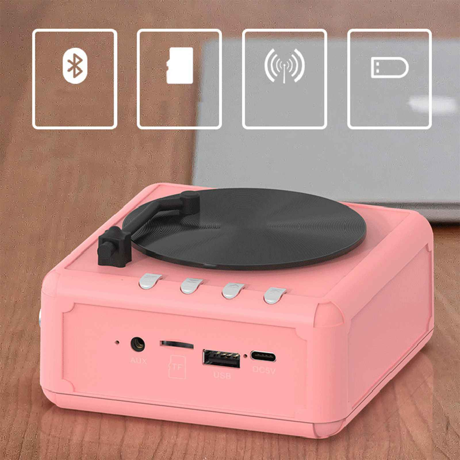 Ein pinkfarbener Lautsprecher im Retro-Stil mit Plattenspieler und Funktionssymbolen.