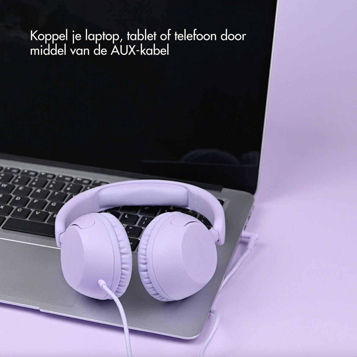 A purple headset rests on a laptop. A cable connects the headset to the laptop on a purple background.