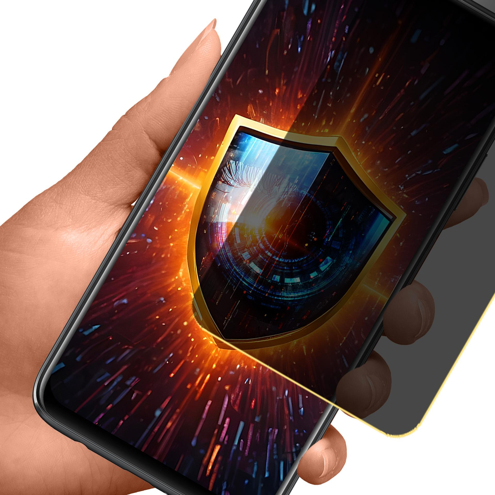 Dłoń trzymająca telefon z ochraniaczem ekranu. Ekran wyświetla grafikę tarczy. Pomarańczowe tło.