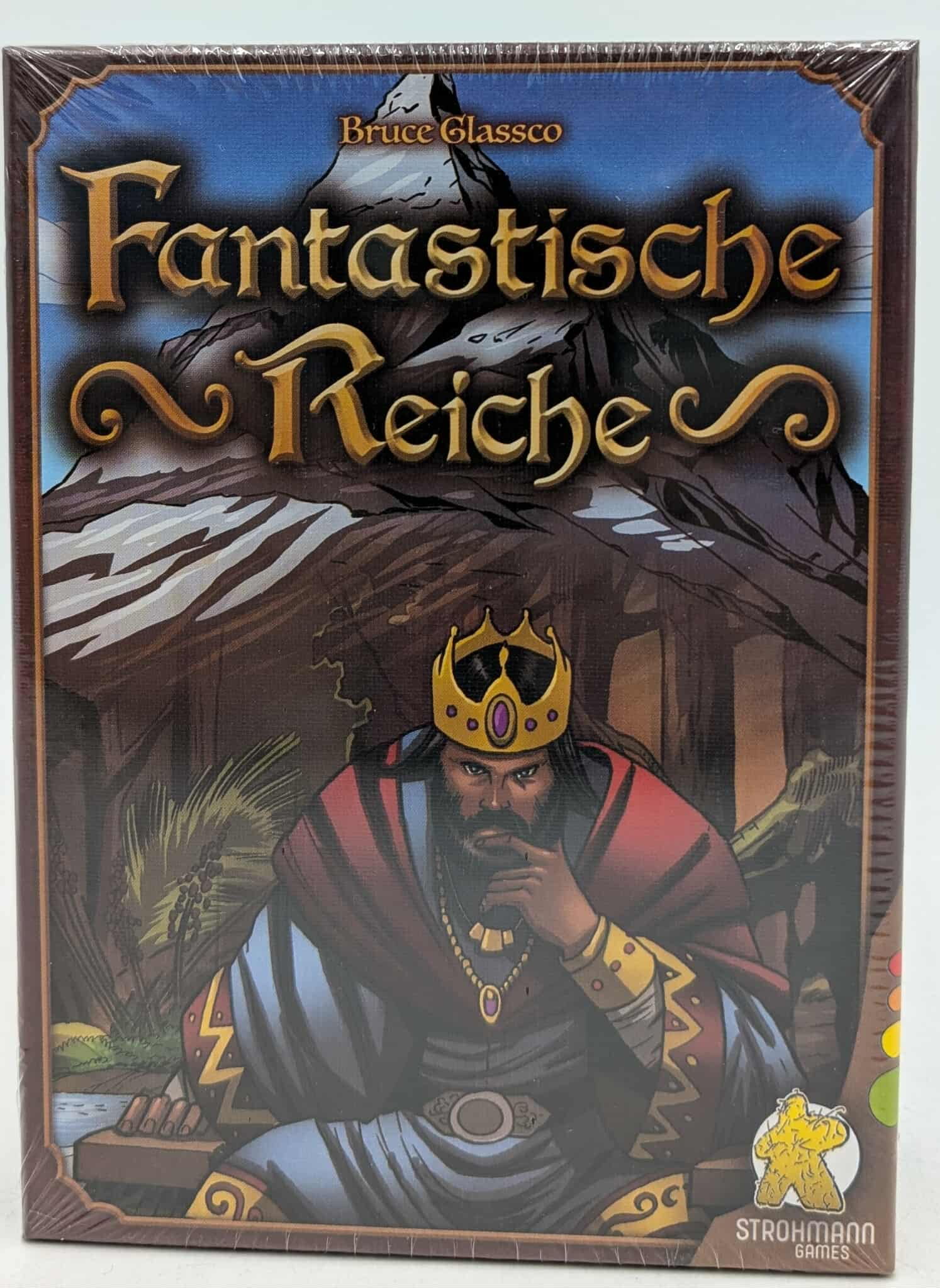 Brettspielbox mit einem König mit Krone, Bergkulisse und dem Titel 'Fantastische Reiche'.