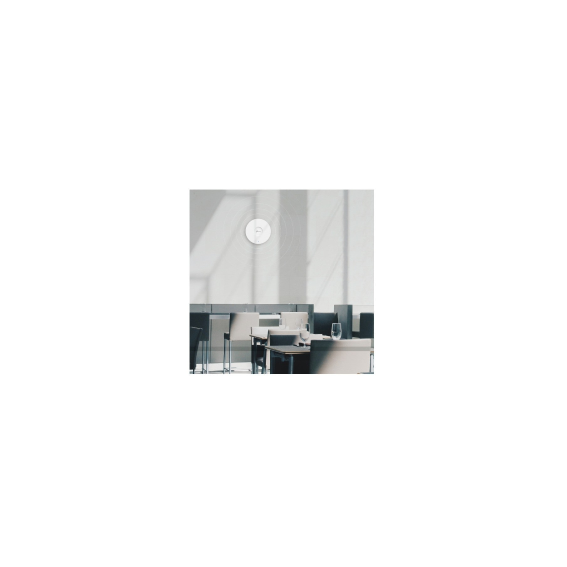 An access point is mounted on a wall. A restaurant setting includes tables and chairs.