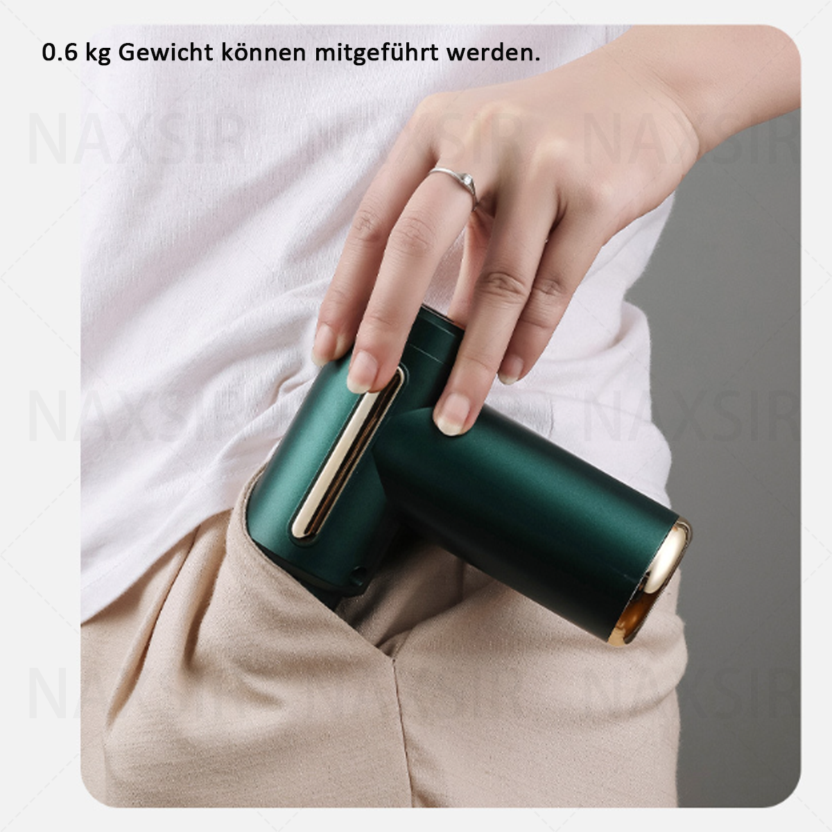 Eine Hand hält eine grün-goldene Massagepistole in einer Tasche. Text: 0,6 kg Gewicht kann mitgeführt werden.